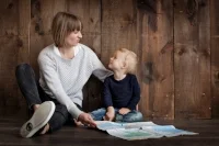 Mother and child sitting on floor