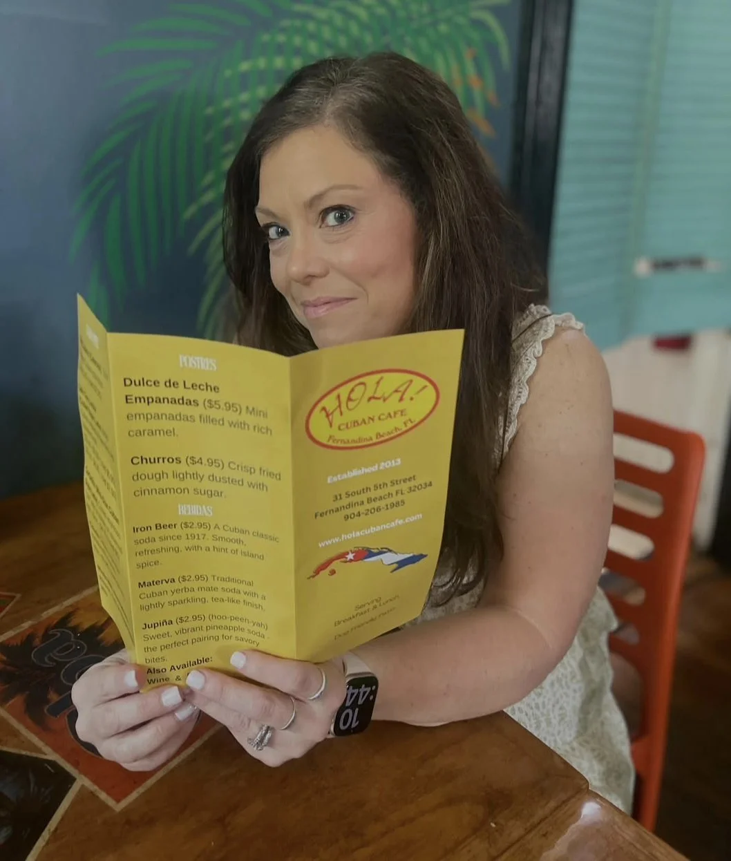 customer-holding-hola-cuban-cafe-menu-fernandina-beach-amelia-island.jpg