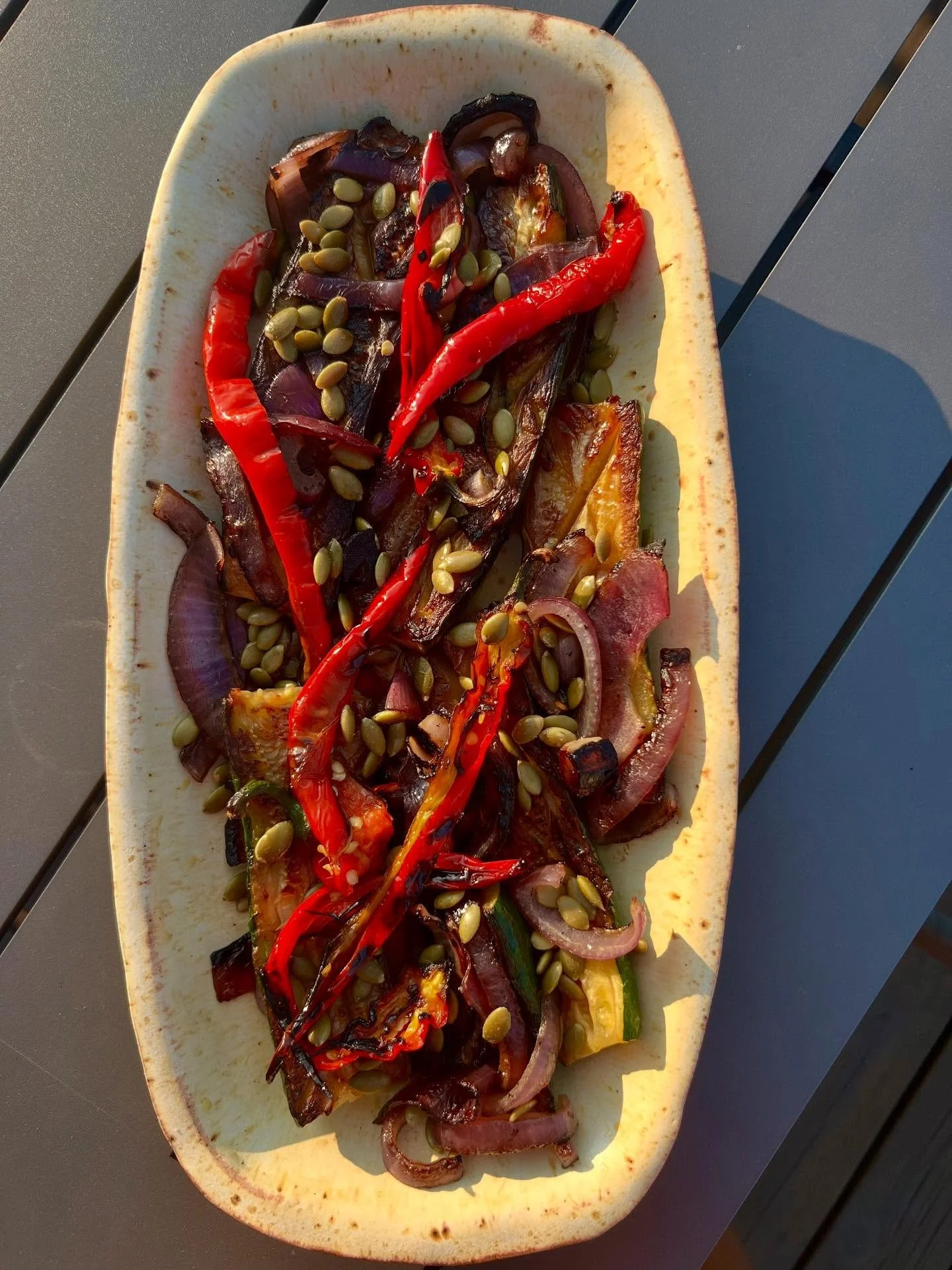 This sunny plate of charred zucchini, Jimmy Nardello peppers, and onions marinated in red wine vinaigrette has become one of my favorite easy summer meals.
Cut 2 or 3 zucchini into planks lengthwise (or across! Do what you want!). Slice a red onion.

