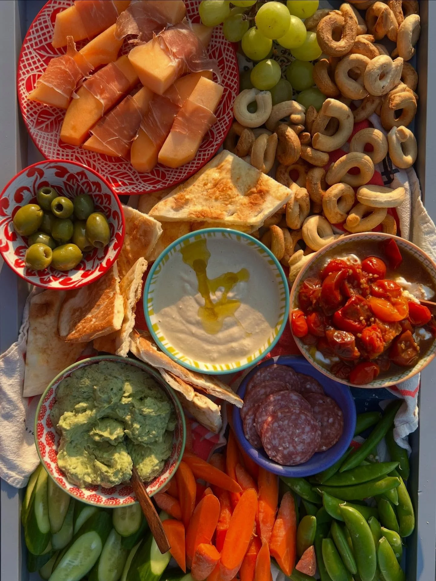 I took it easy when having friends over this summer, making these probably fairly bougie but easy snack trays. They don&rsquo;t need to be complicated.  Pick up or make a few dips. Add some charcuterie and cheese. Cut up some veggies, and arrange the