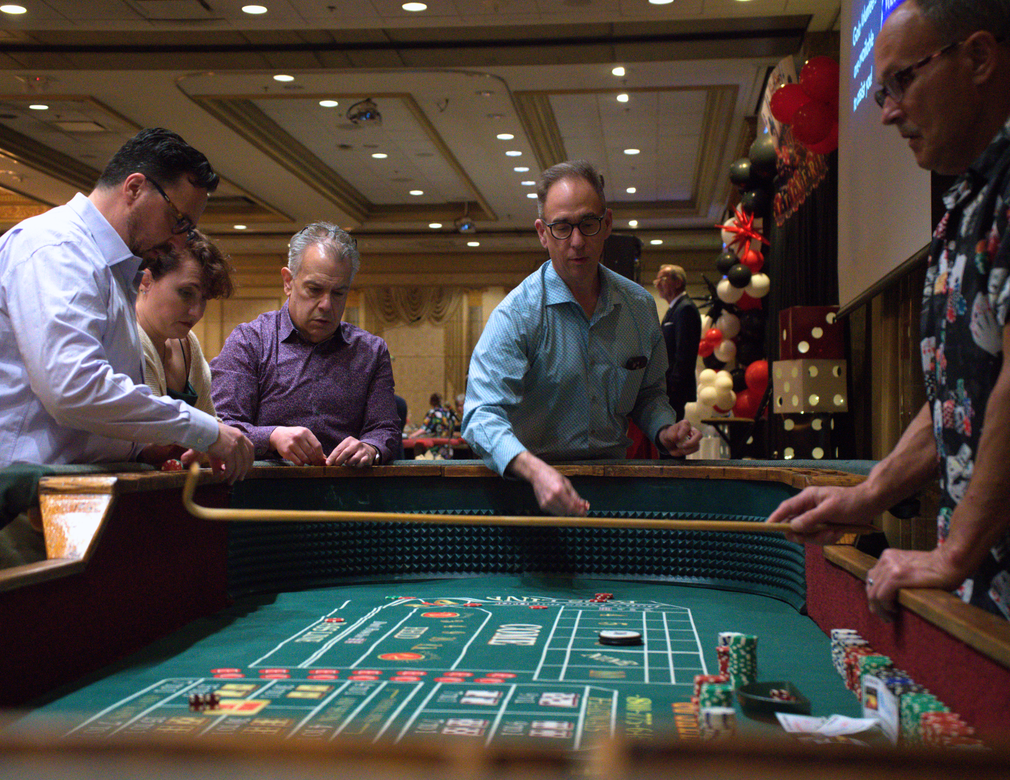 three men and one woman playing craps.