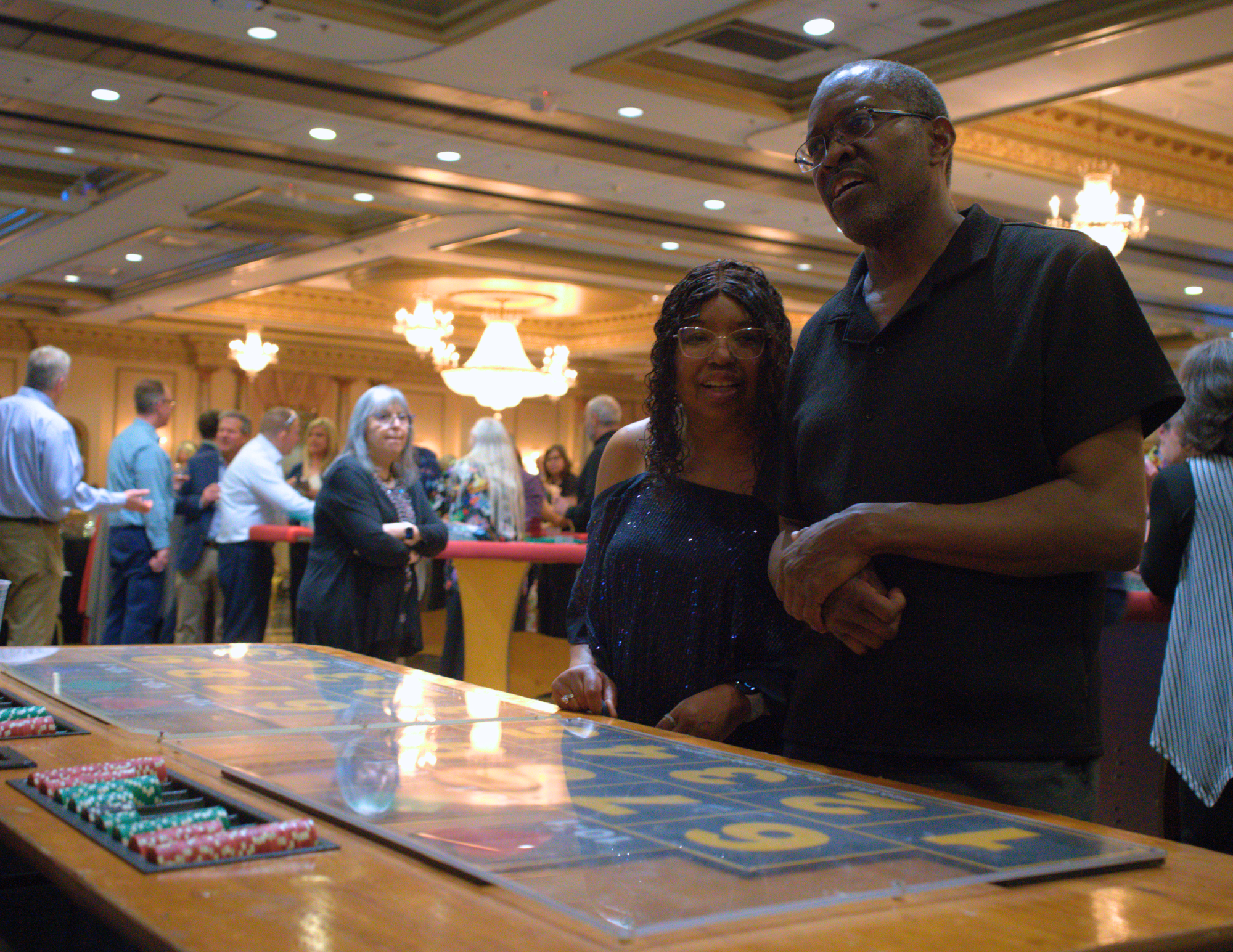 a black couple looking at the money wheel.