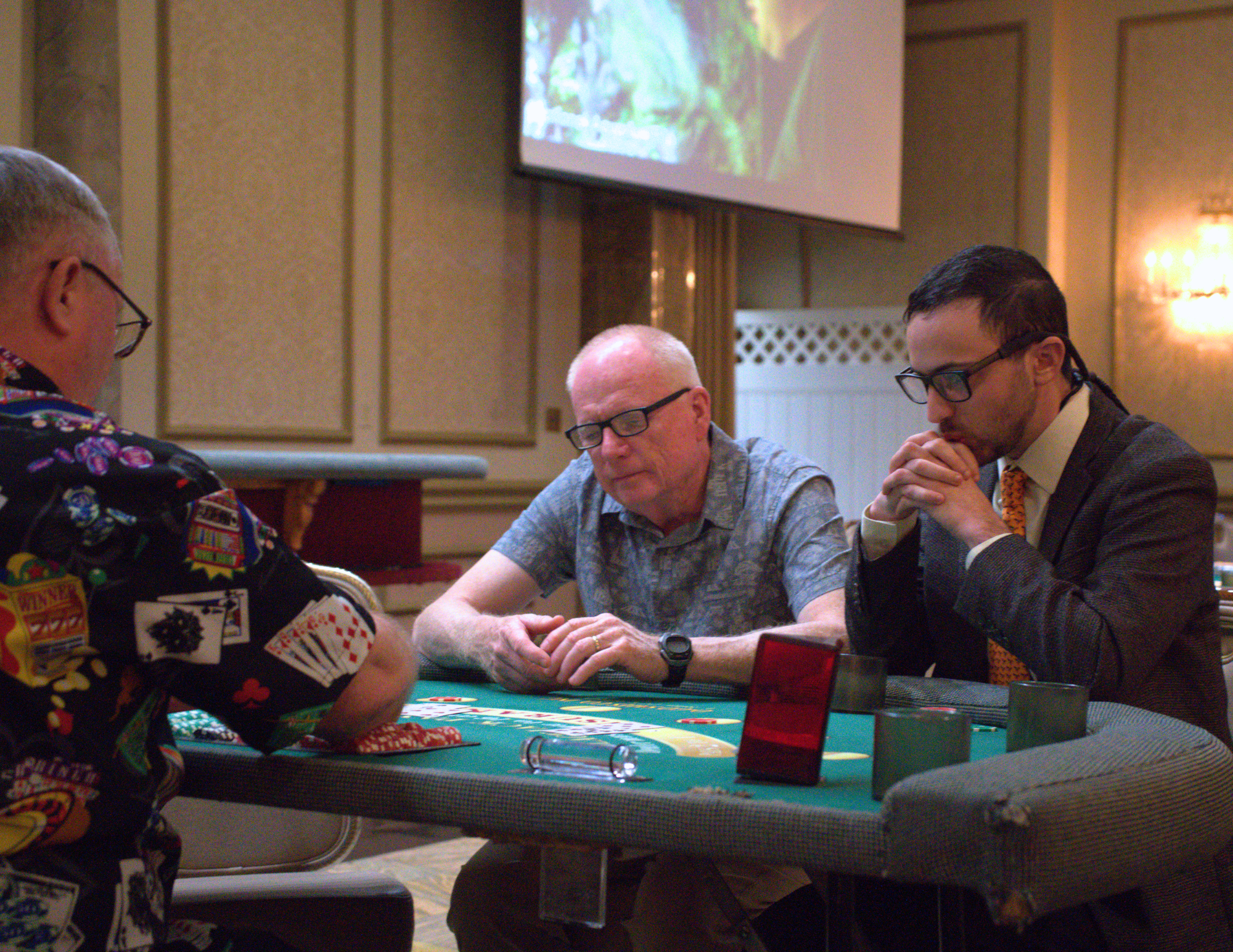 two men wearing glasses playing blackjack.