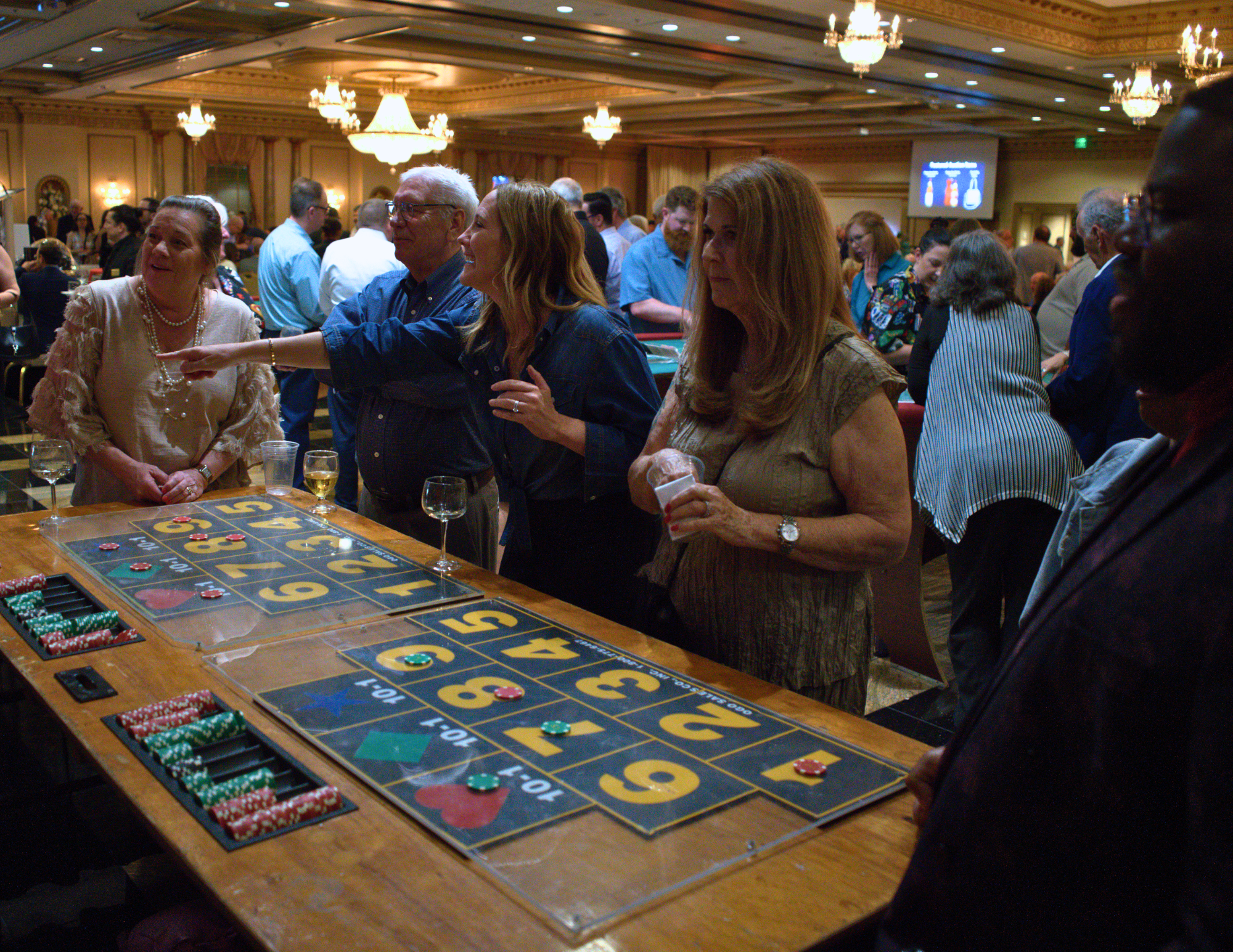 people at the money wheel looking and cheering.