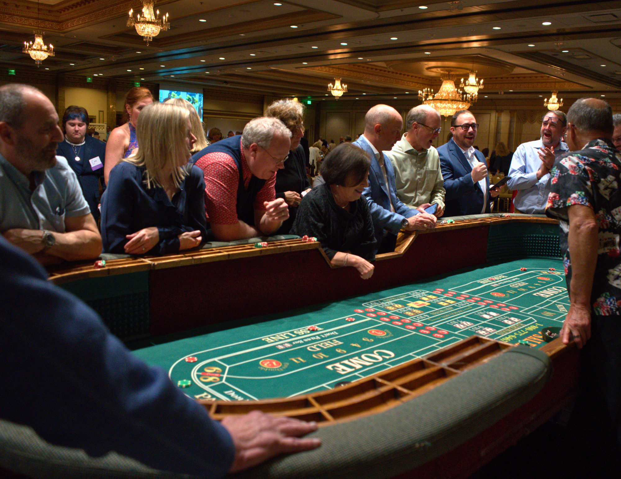 a large group of people cheering playing craps.