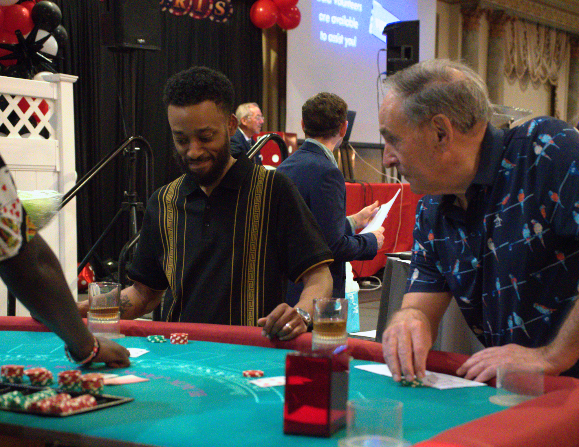 two men, one old and one young, playing blackjack.