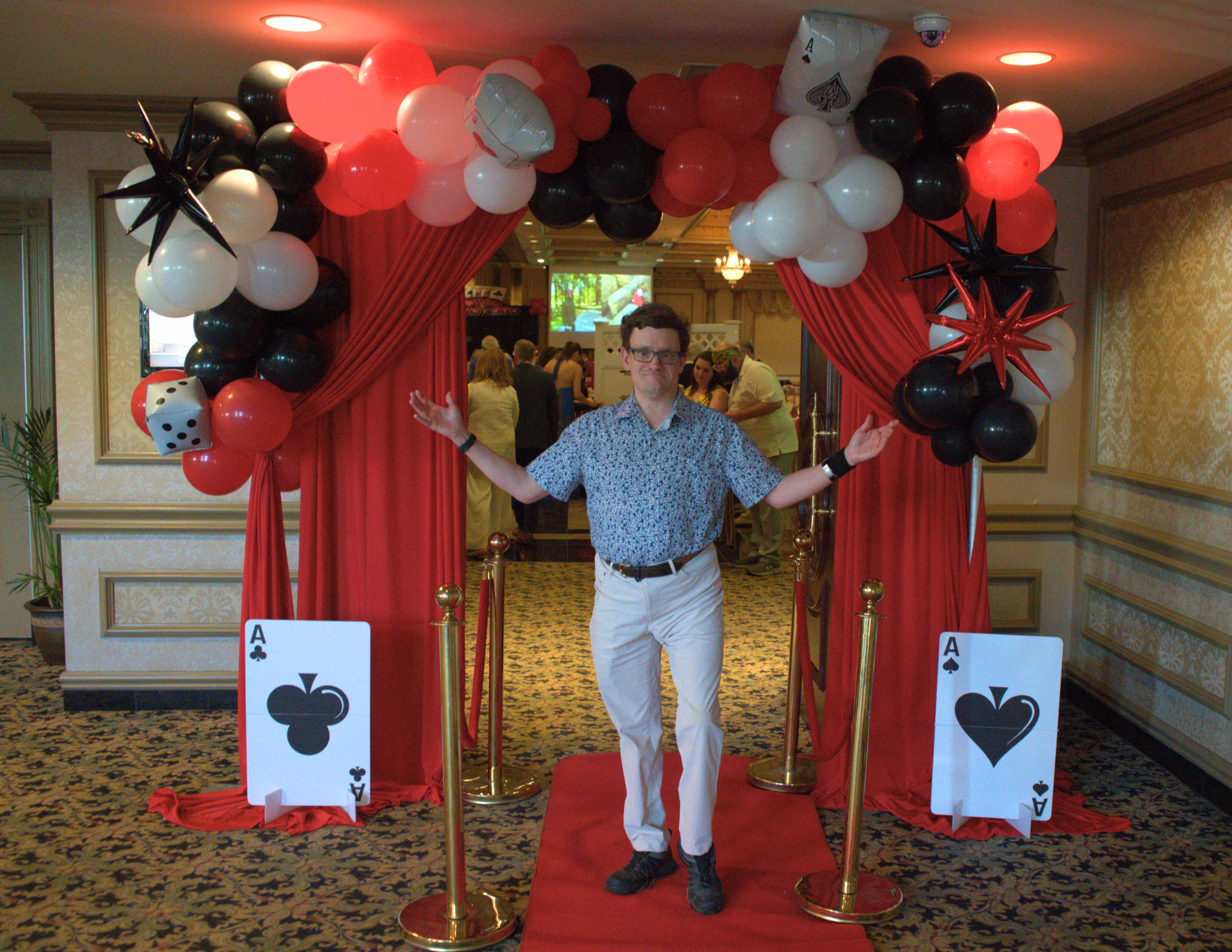 an autistic adult showing off the casino decorations in the ballroom.