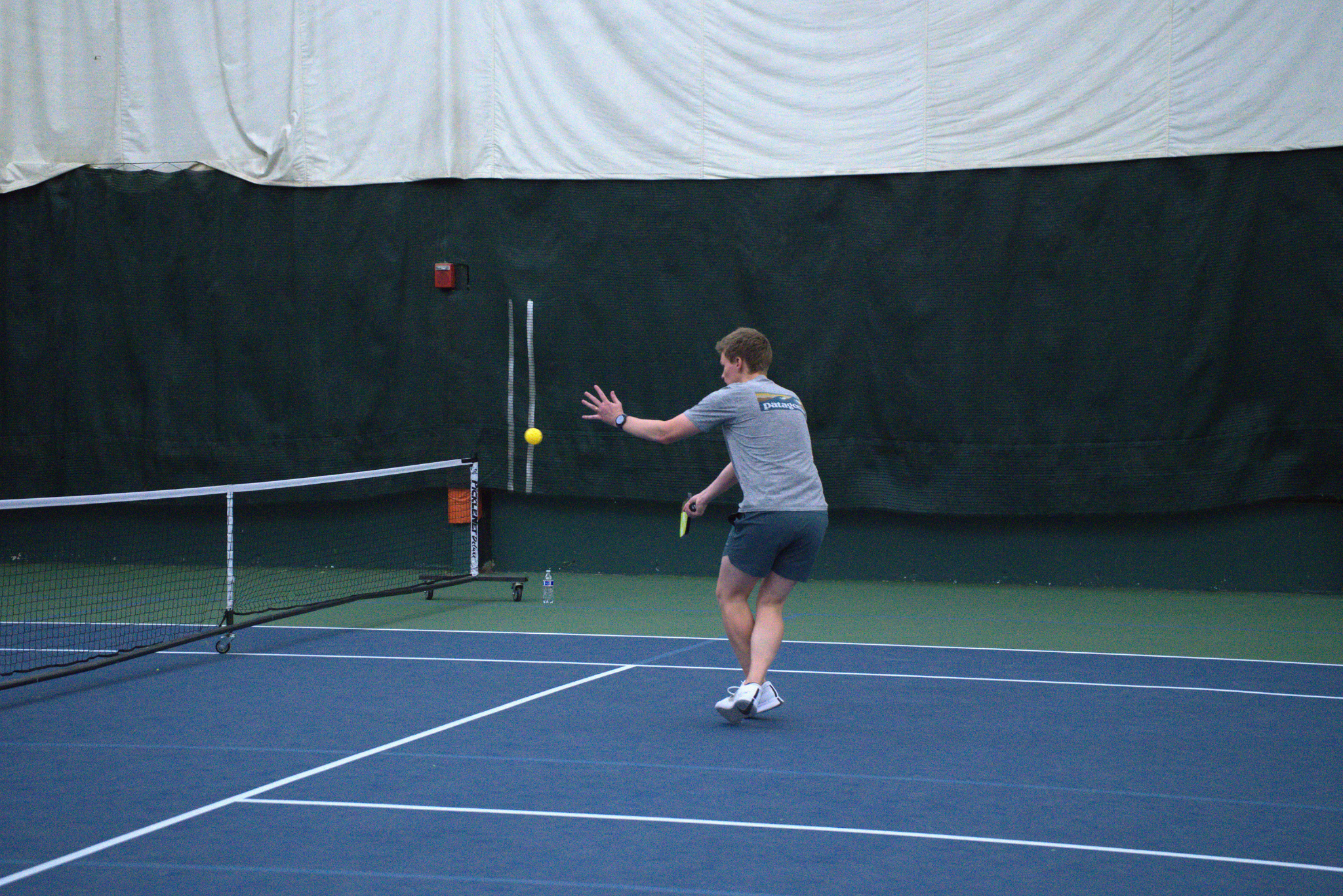 a man playing pickleball.