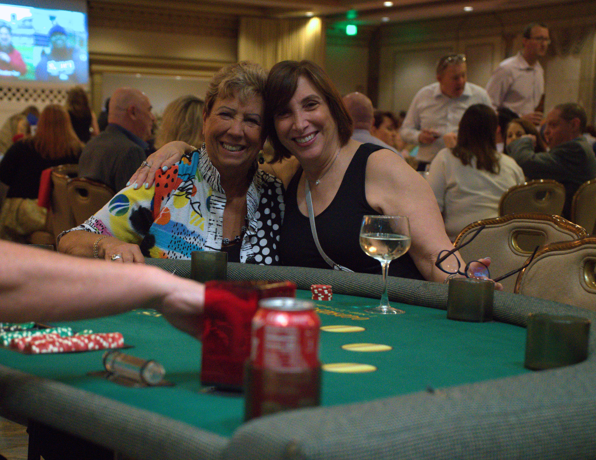 two women smiling at the blackjack table.