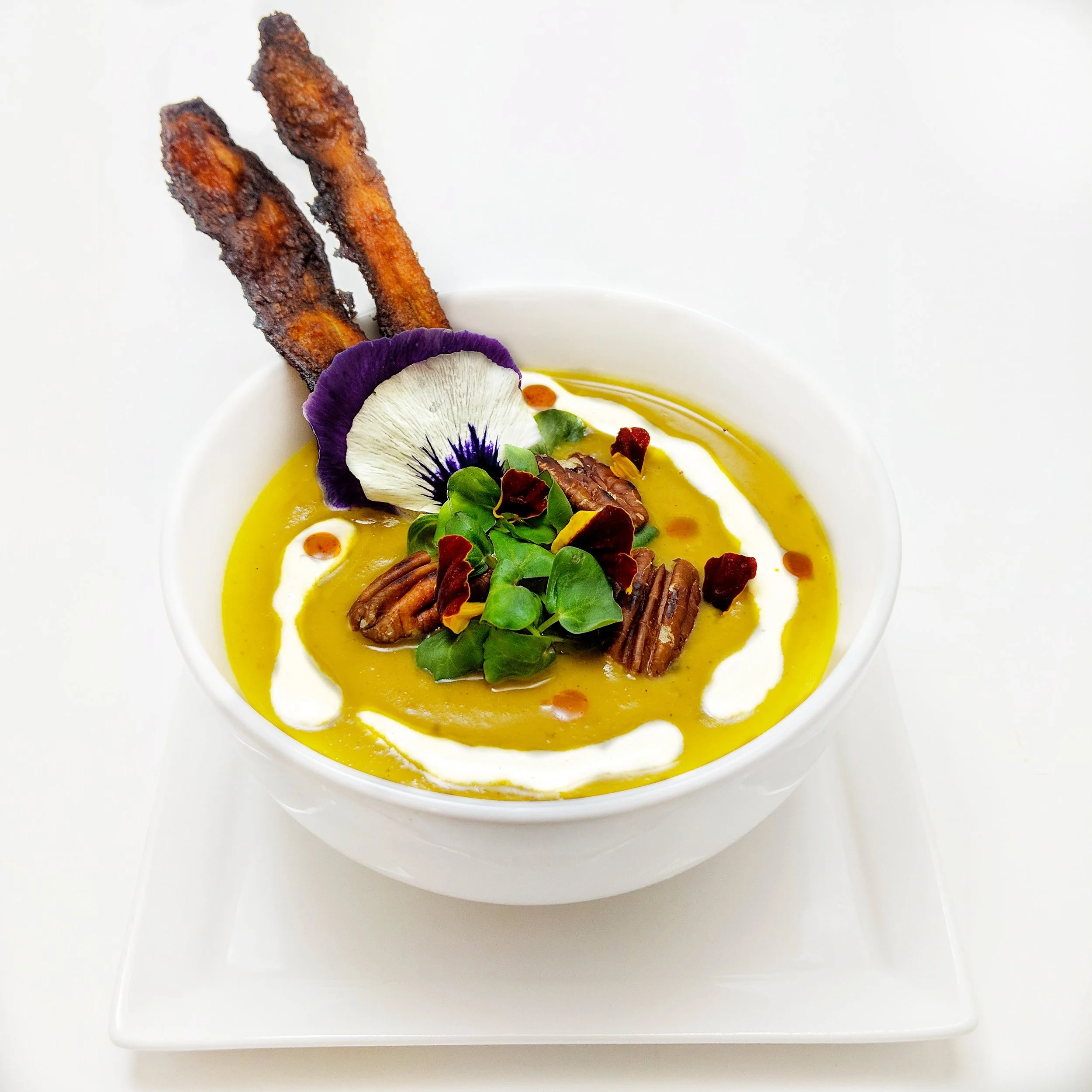 Sweet Potato Bisque with Maple Cashew Cream, Chipotle Oil, Carrot Bacon, and Smoked Pecans