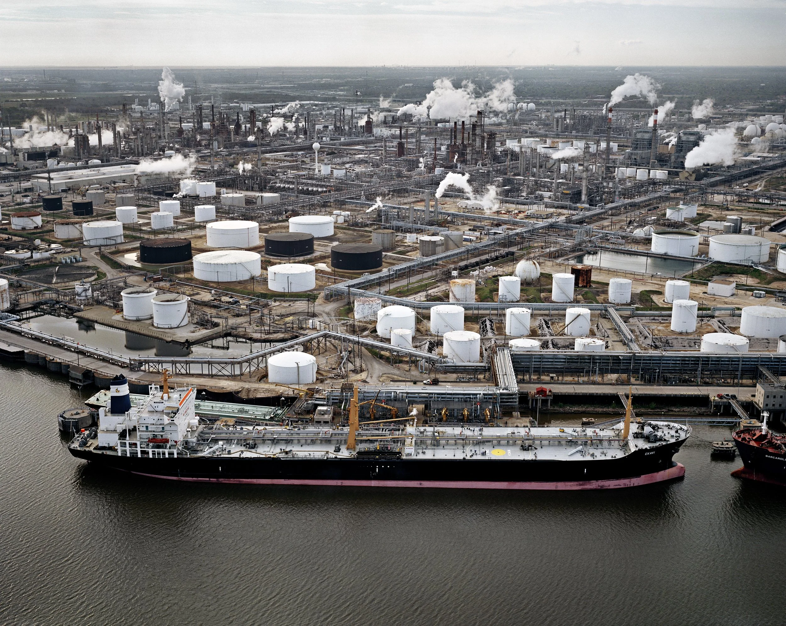 Edward Burtynsky, Oil Tanker and Refineries, Pasadena, Texas, USA, 2004. Chromogenic color print. Collection of the Nevada Museum of Art, The Altered Landscape, Carol Franc Buck Collection. (Photograph © Edward Burtynsky, courtesy Metivier Gallery Toronto / Von Lintel Gallery, Los Angeles)