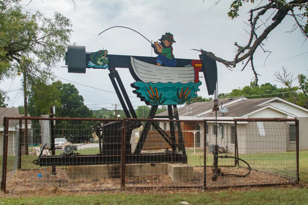 Angler in a Boat , George Kalesik, surrounded by residences. Photo: Laura Napier