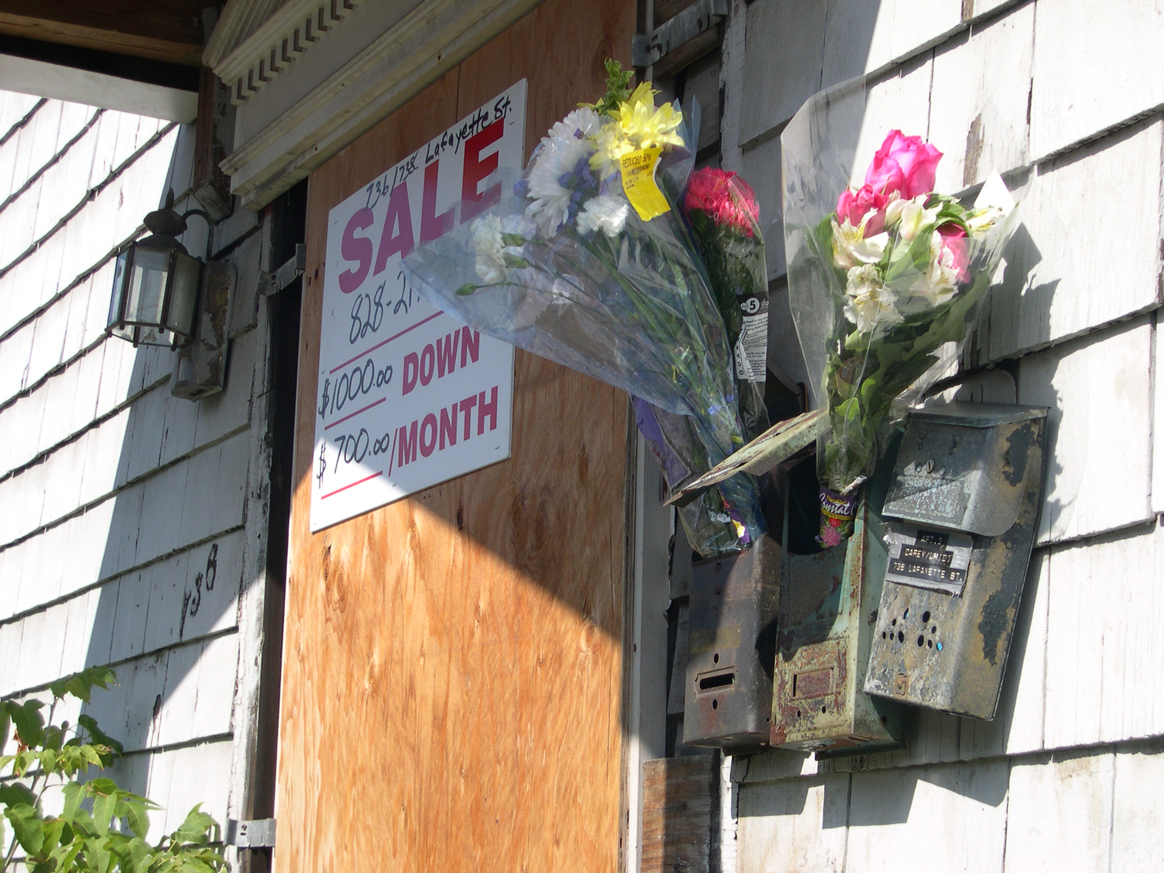 Reduced for Quick Sale , 2004; Discounted bouquets delivered to the boarded up houses that surround an upstate New York artists residency.