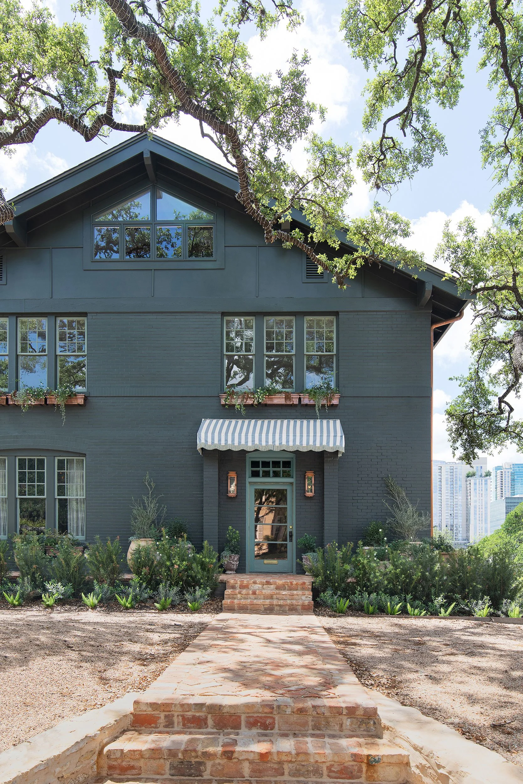 Front exterior from the West House project, designed by Chelsea Kloss with LV Collective, Austin Texas, photography by Avery Nicole Photography