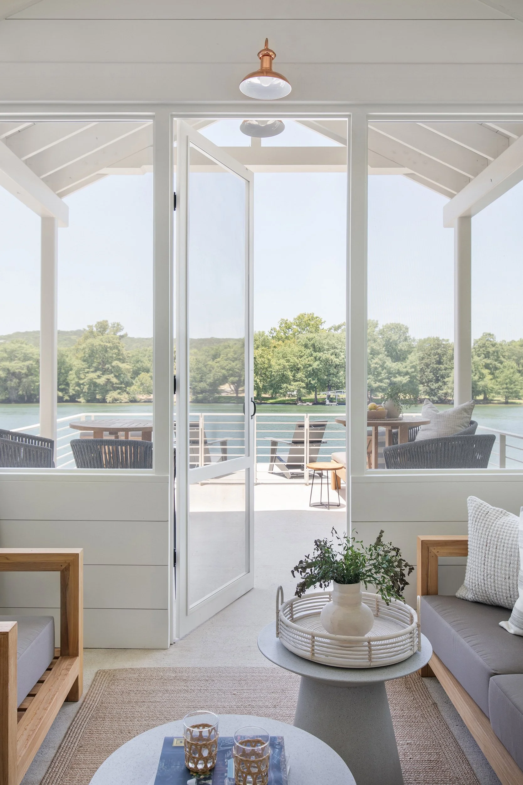 Seating area from The Toad Inn boathouse, designed by The Pankonien Group, Lake Austin, Austin Texas, photography by Avery Nicole Photography