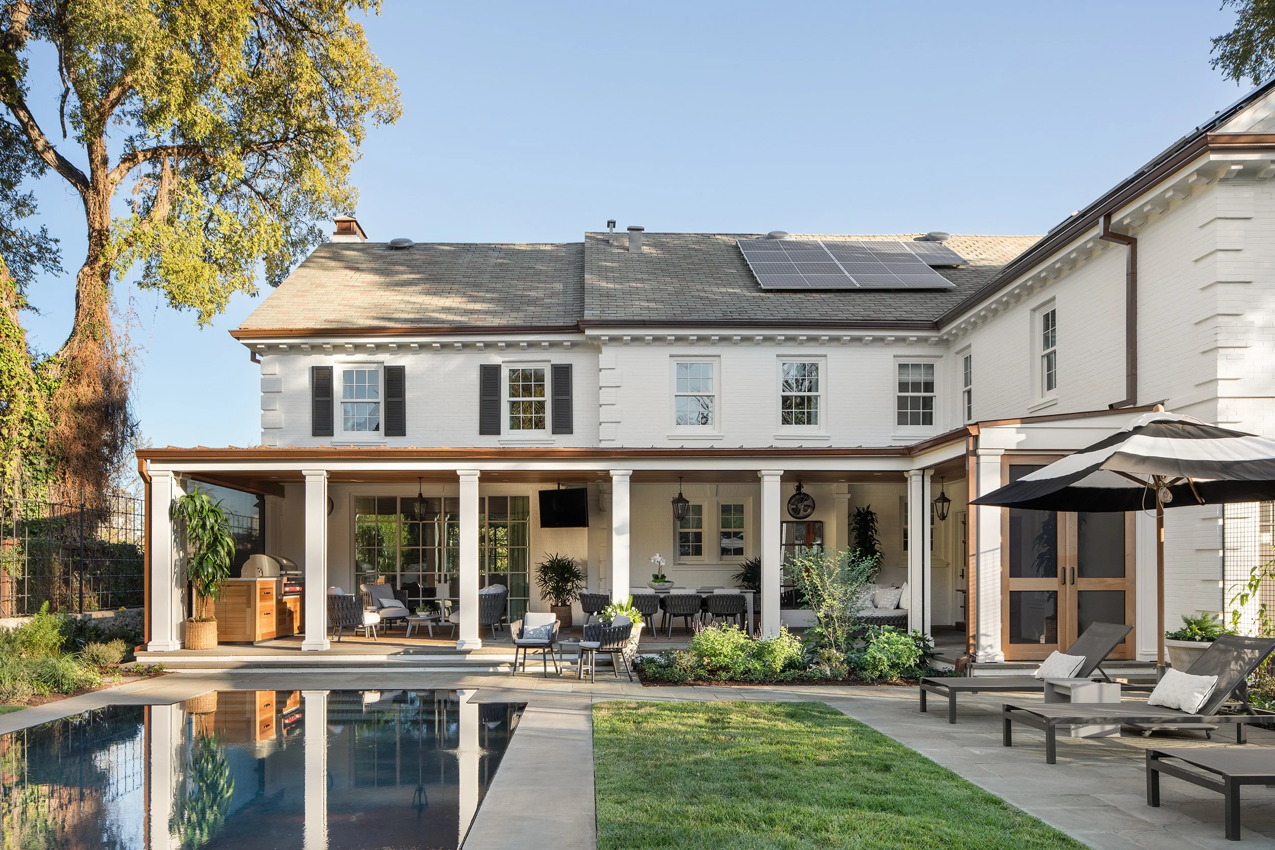Old Enfield Estate back exterior by Grasso Gay Architects and built by Messer Design + Construction, residential photography by Avery Nicole Photography and located in Old Enfield Neighborhood in Austin, Texas