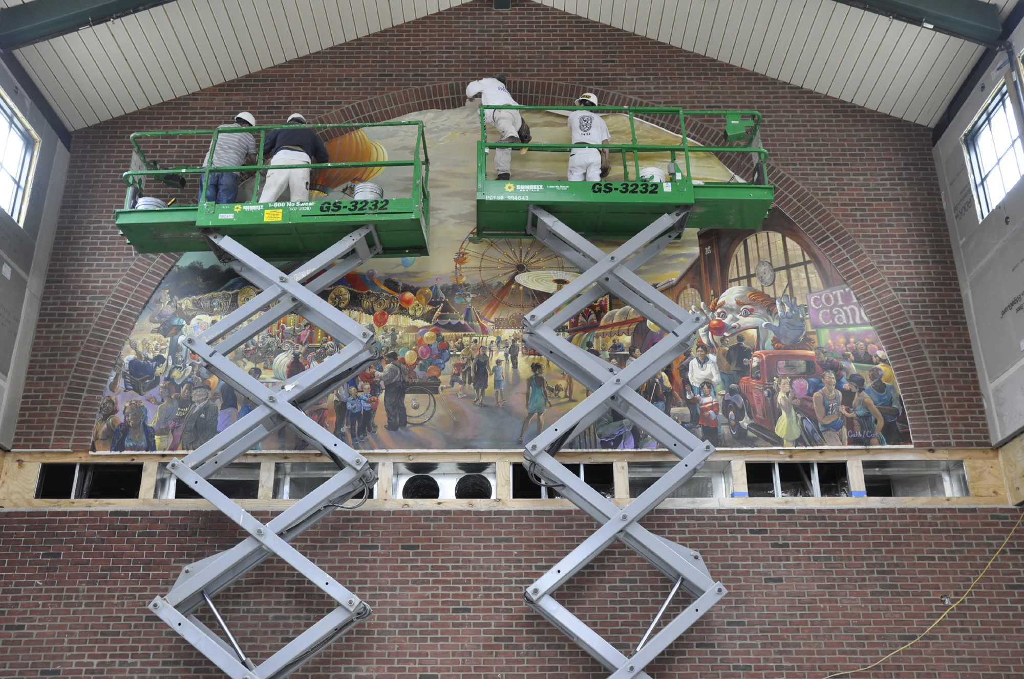 It takes a team to hang and adhere these murals!