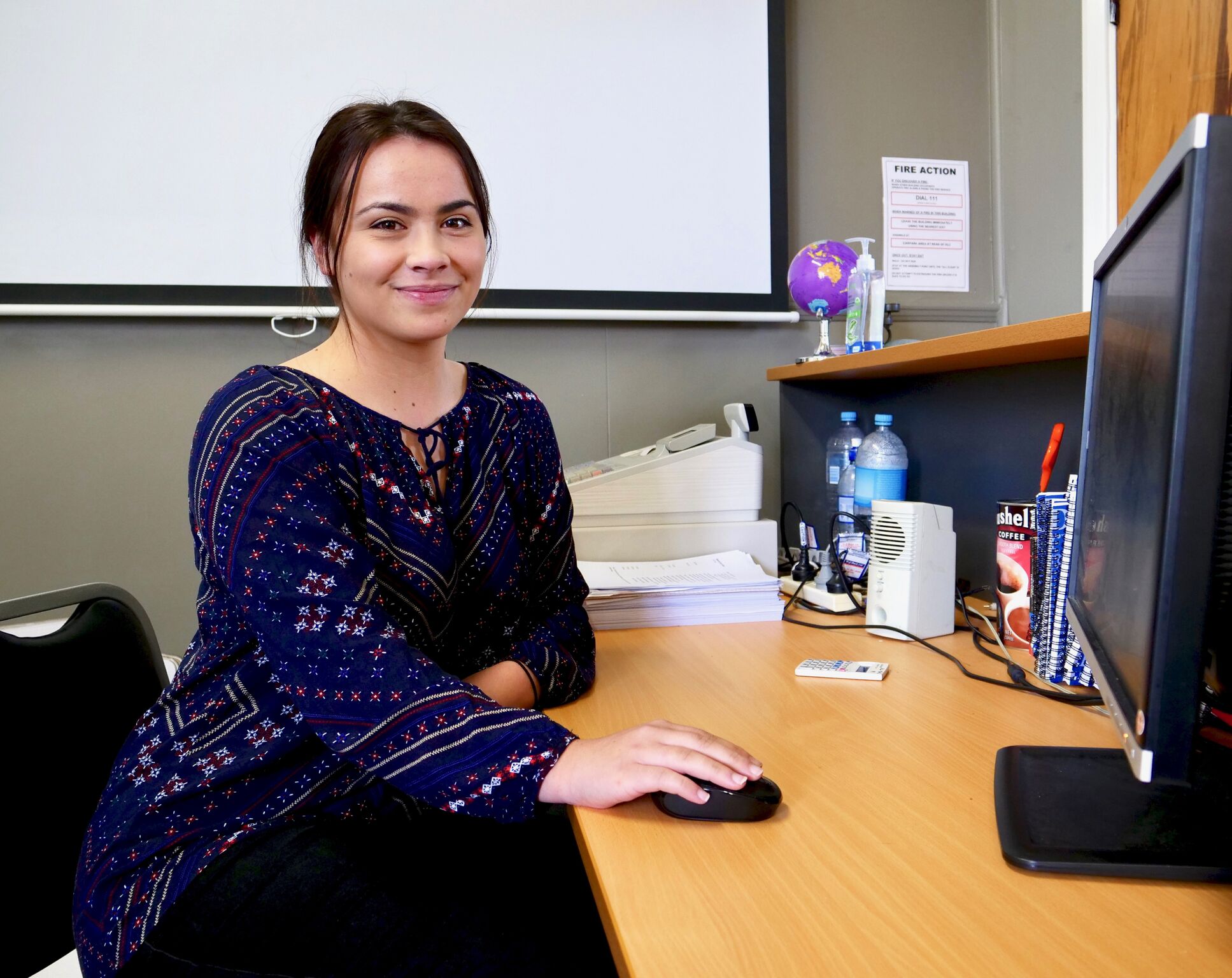 Business student at desk in classroom