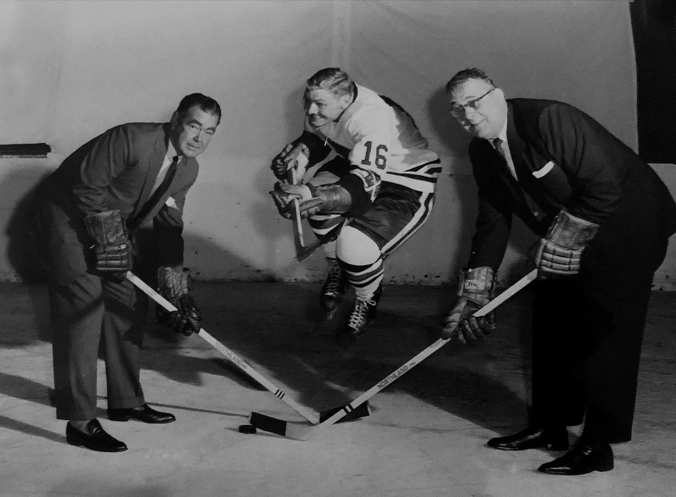  Arthur ( right ) with partner Jimmy Norris. In between them, superstar player Bobby Hull clowns around in his original number 16 jersey from his first few years with the Blackhawks (1957 to 1961). Hull later switched to number 7 and again to the now