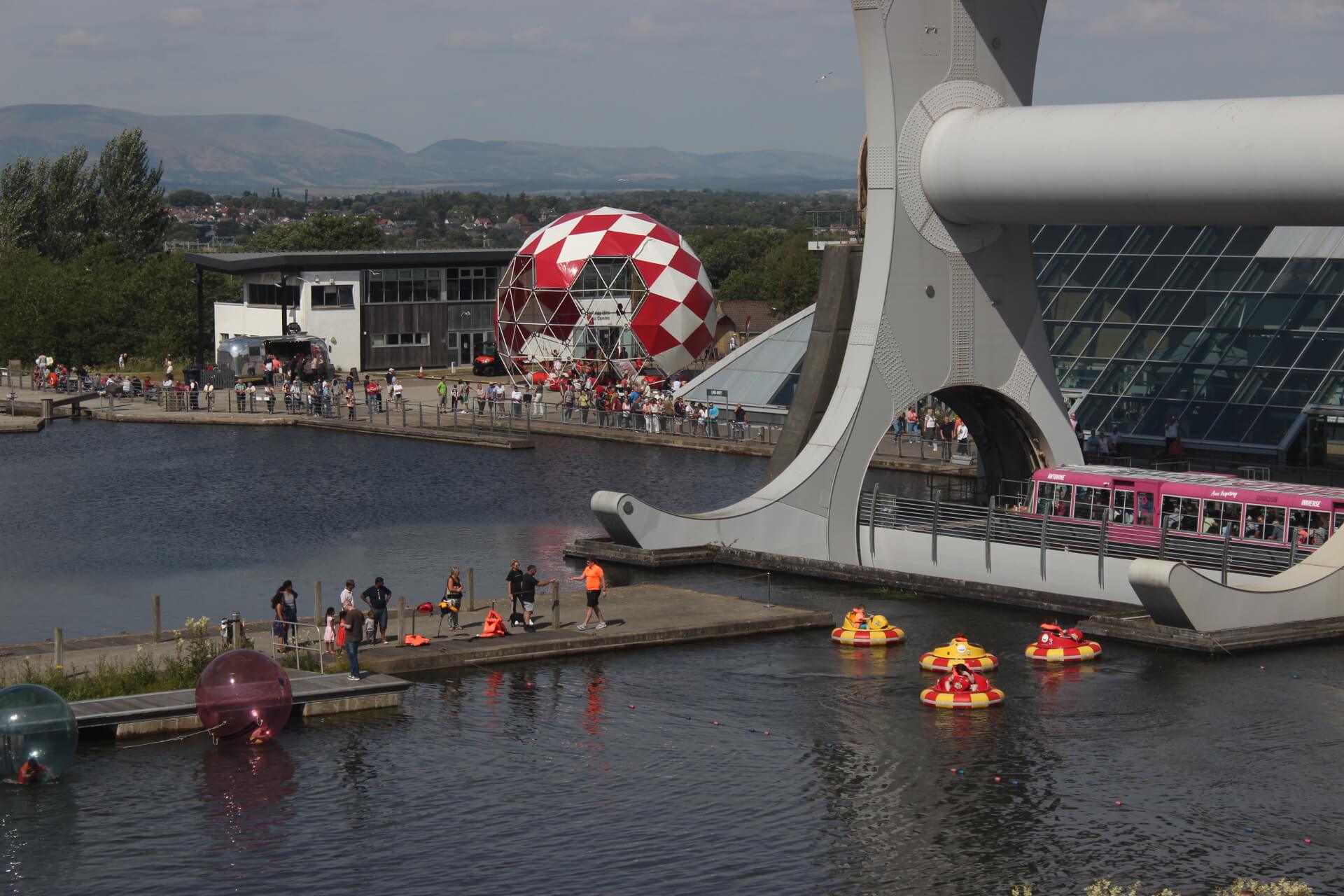   Falkirk Wheel   bubbleparc_Falkirk showcases the bungydome in its brightest red and white coat, performing in front of the awe inspiring and world famous Falkirk Wheel. &nbsp; 