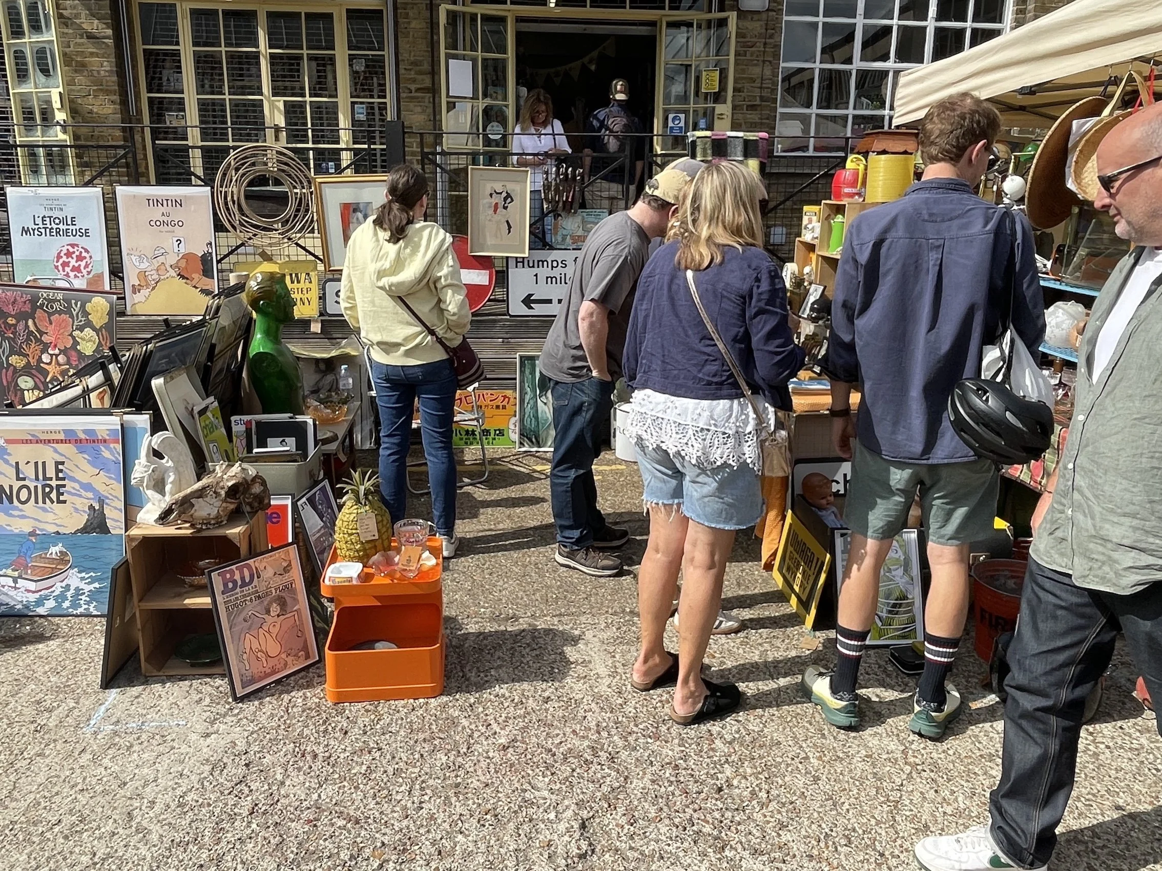 stall selling vintage posters, roadsigns, homeware and other items outside the 1929 Shop at So Last Century's vintage market at Merton Abbey Mills