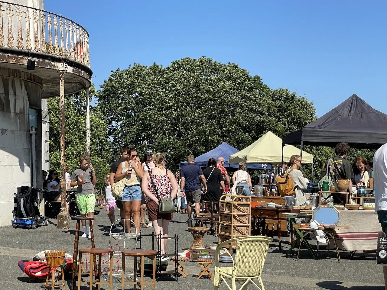 people browsing vintage stalls at back of the Mansion, Beckenham Place Park, south east London