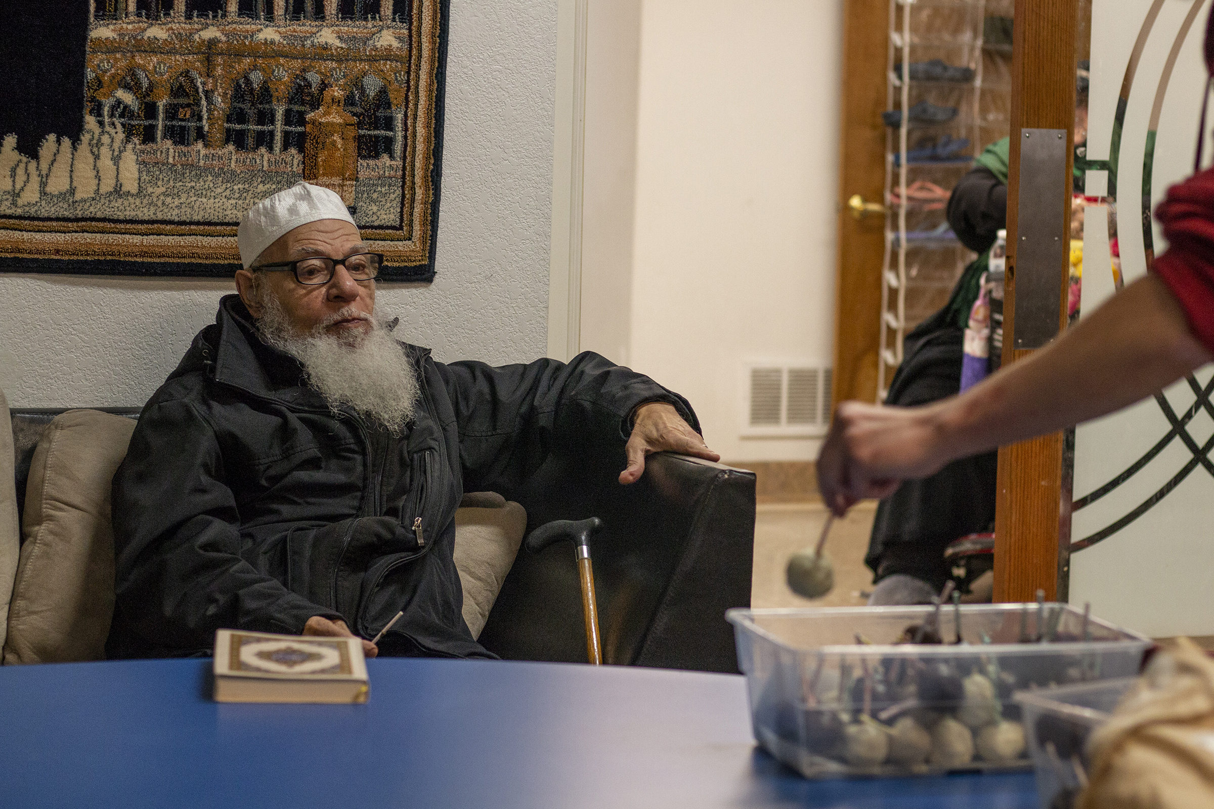  Elsherif eyes a cake pop after eating one of the freshly baked desserts. Community members of the Eugene Islamic Center commonly bring food in for snacks after prayer. 