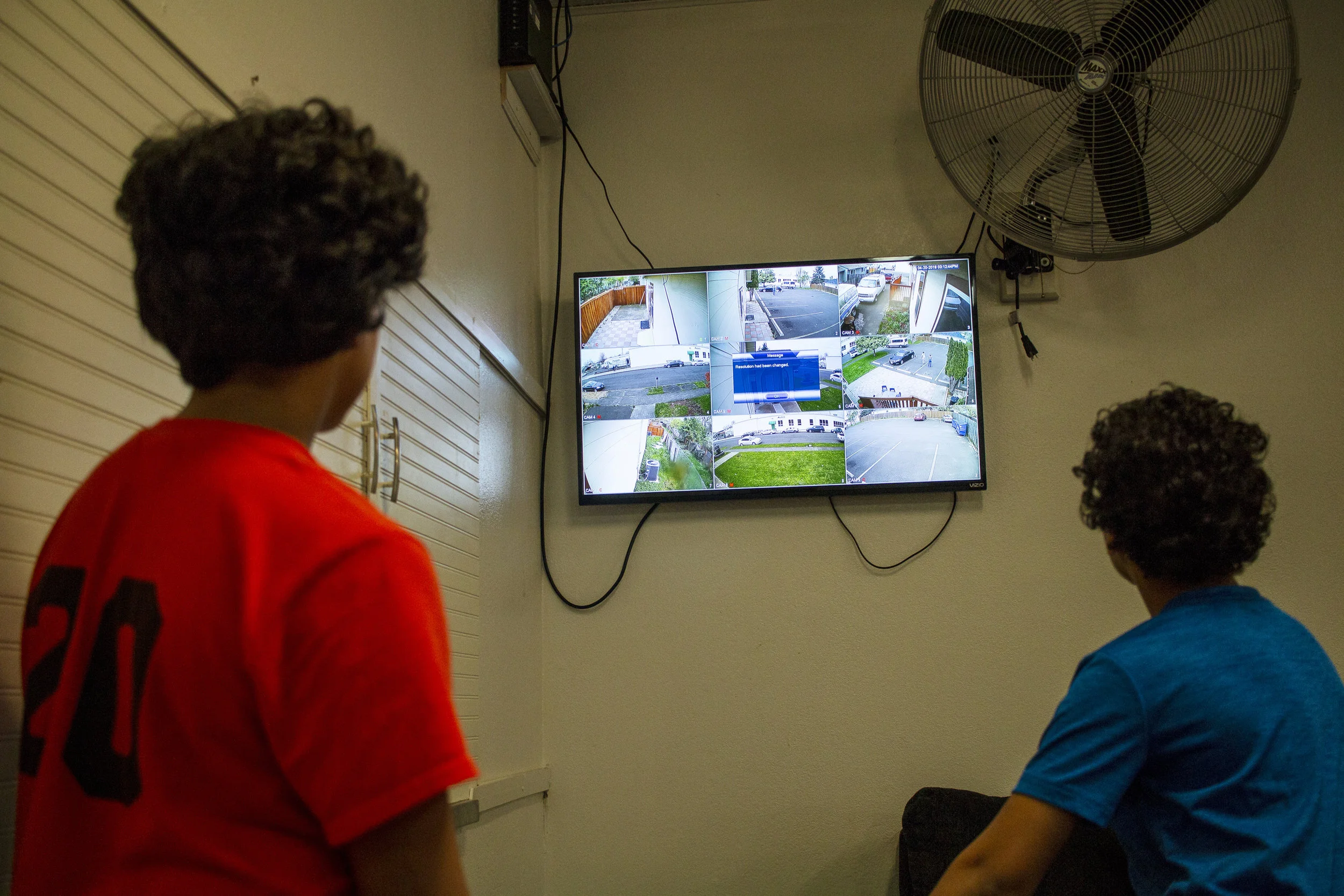  Hasan Eissa, left, and Belal Eissa, right, watch a flat-screen television connected to the security cameras setup around the Eugene Islamic Center. A security camera system was purchased for the Mosque after a Eugene resident, Chad Russel, came to t