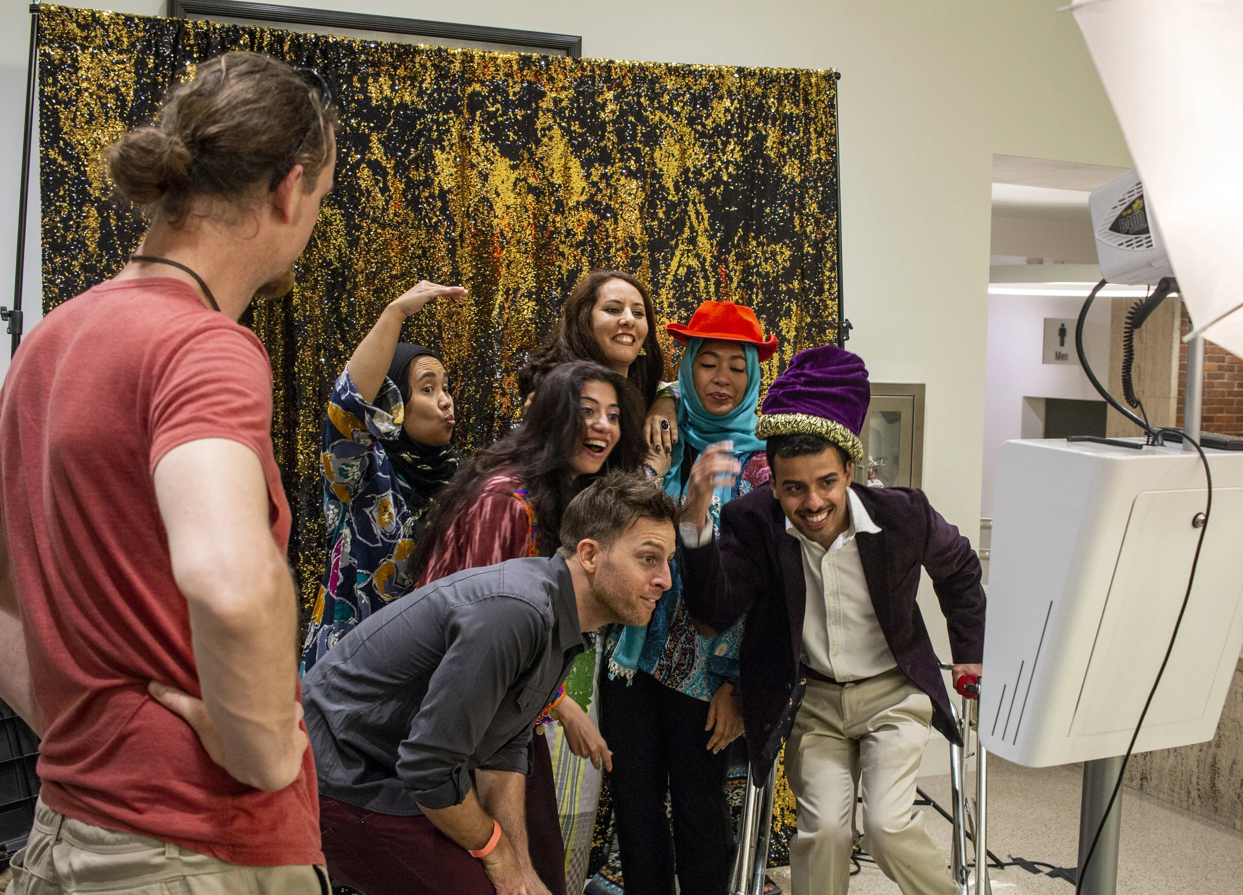  Attendees of Arabian Night pose for a photo with Moezzi after his comedy show concluded. 