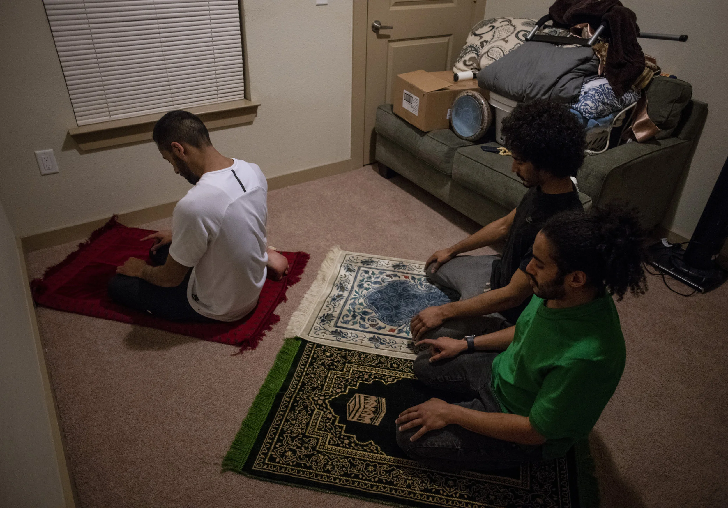  Babaeer, Ebinghannam and Alarfas praying before they break their Ramadan fast for the day. Babaeer, Ebinghannam and Alarfas all live together and have a dedicated room in their apartment for prayer. 