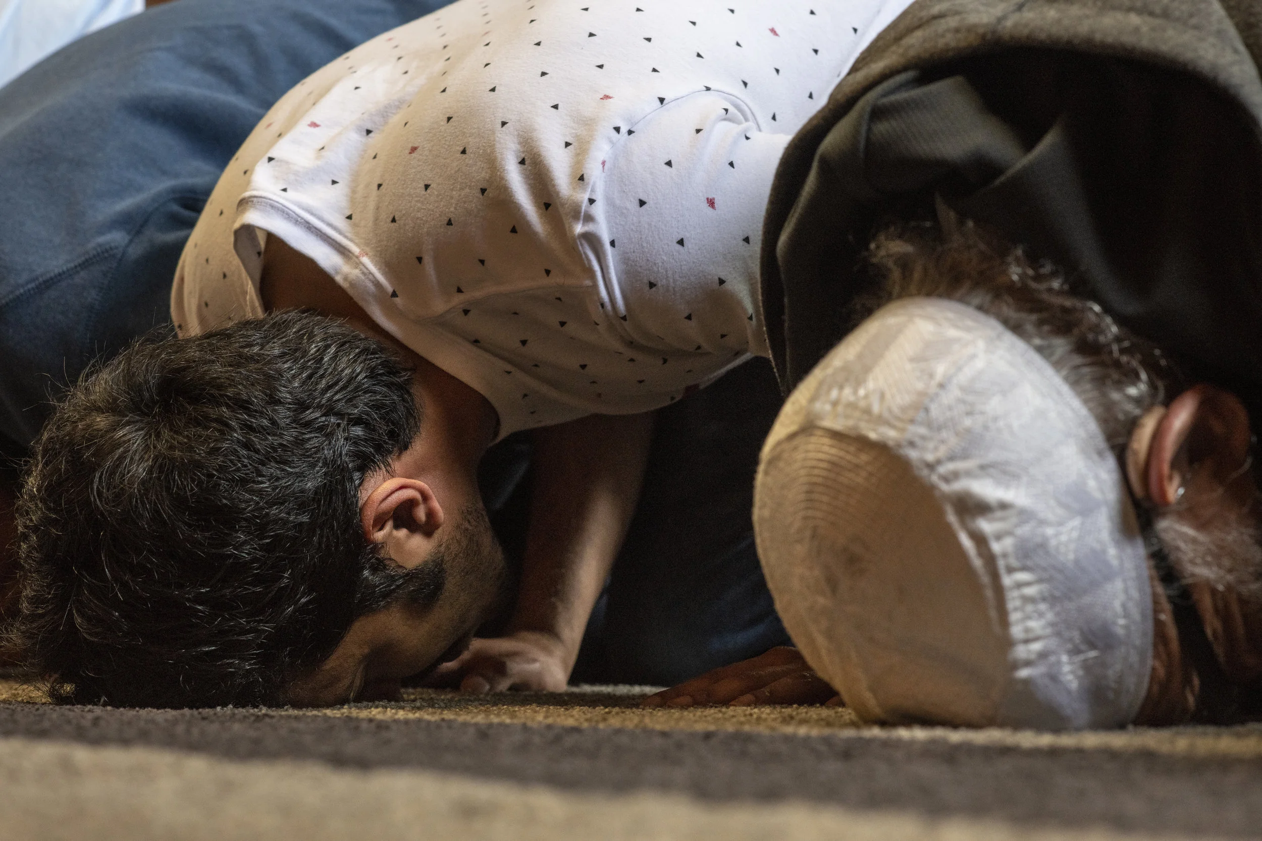  Badr Alsultan, left, and Elsherif, right, bow during prayer at the Eugene Islamic Center. Muslims place their foreheads on the ground during prayer in order to demonstrate prostration and faith in Allah, the sole god in Islam. 