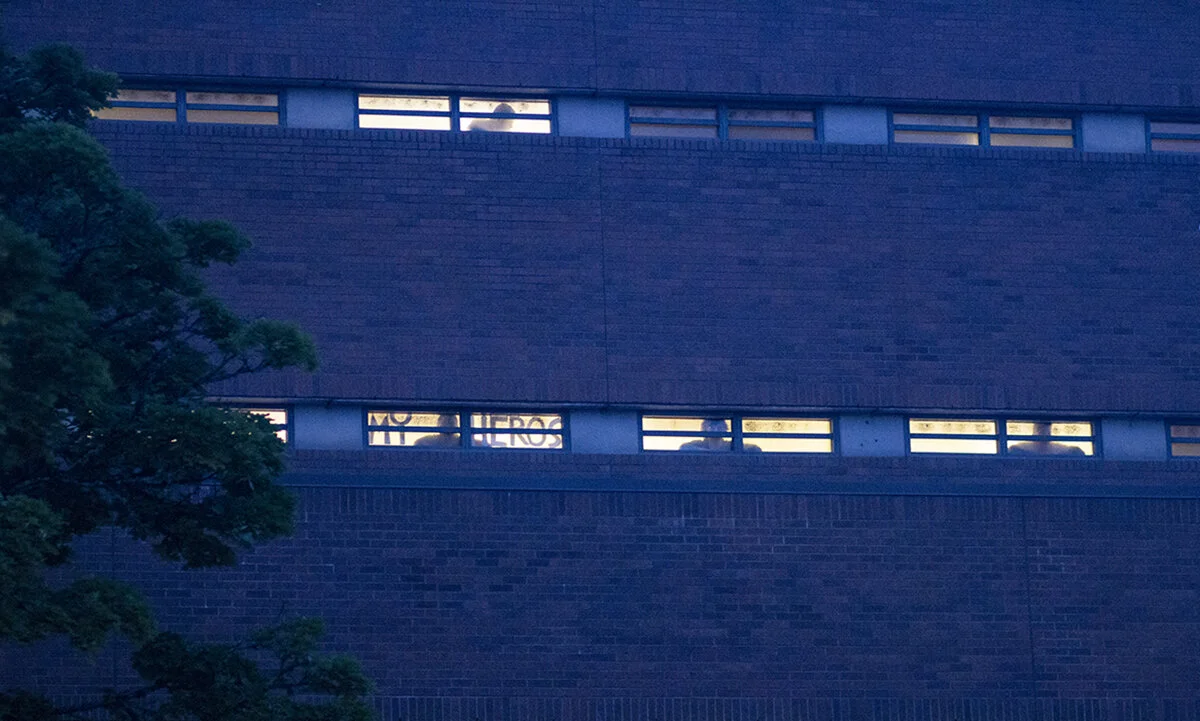  People watching the protest and fireworks from inside the Lane County Jail in Eugene, Oregon. Approximately 200 people gathered at the Lane County jail on Wednesday, July 1, to call for the release of recently jailed strikers and to protest conditio