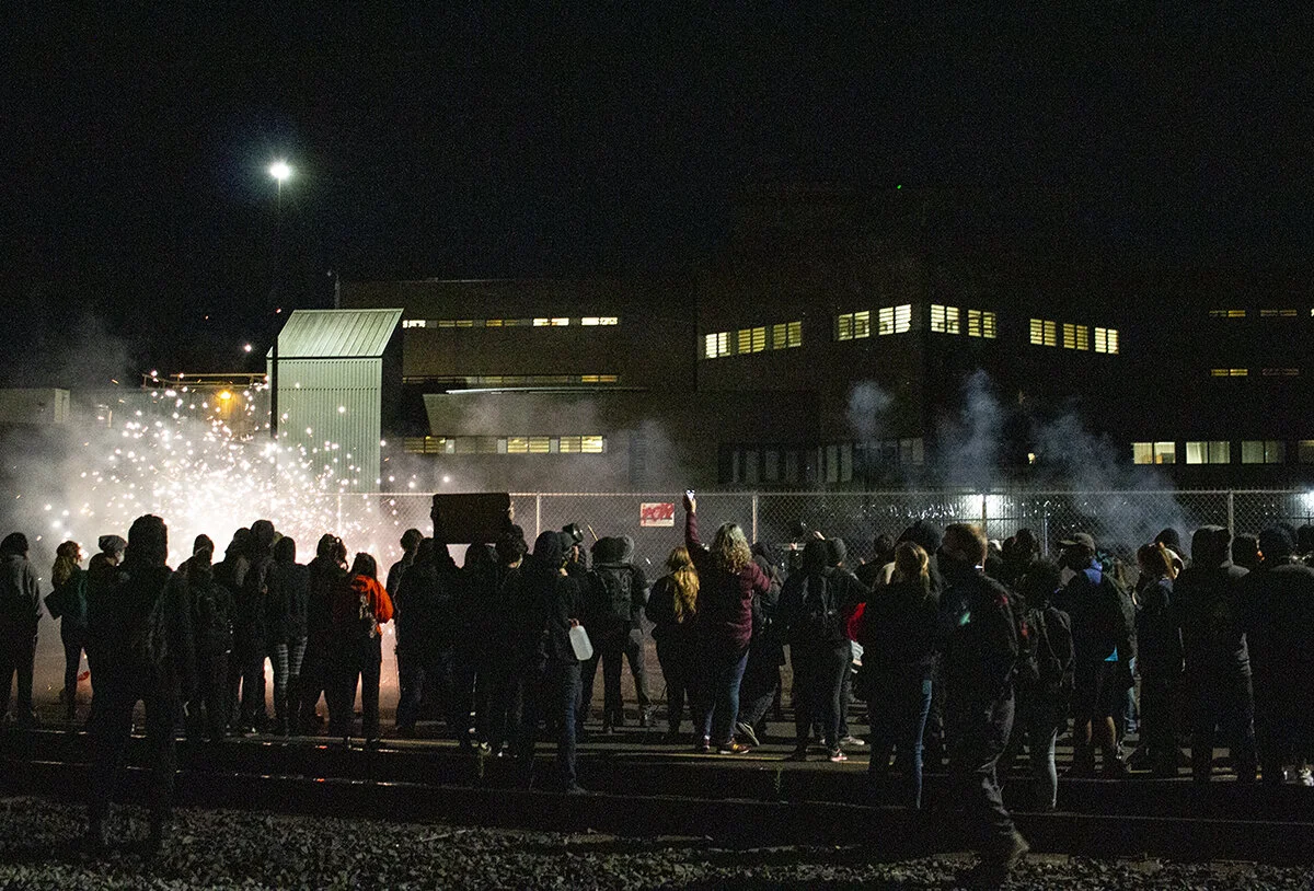  Protesters chanting and lighting fireworks behind the Lane County jail in Eugene, Oregon. Approximately 200 people gathered at the Lane County jail on Wednesday, July 1, to call for the release of recently jailed strikers and to protest conditions t
