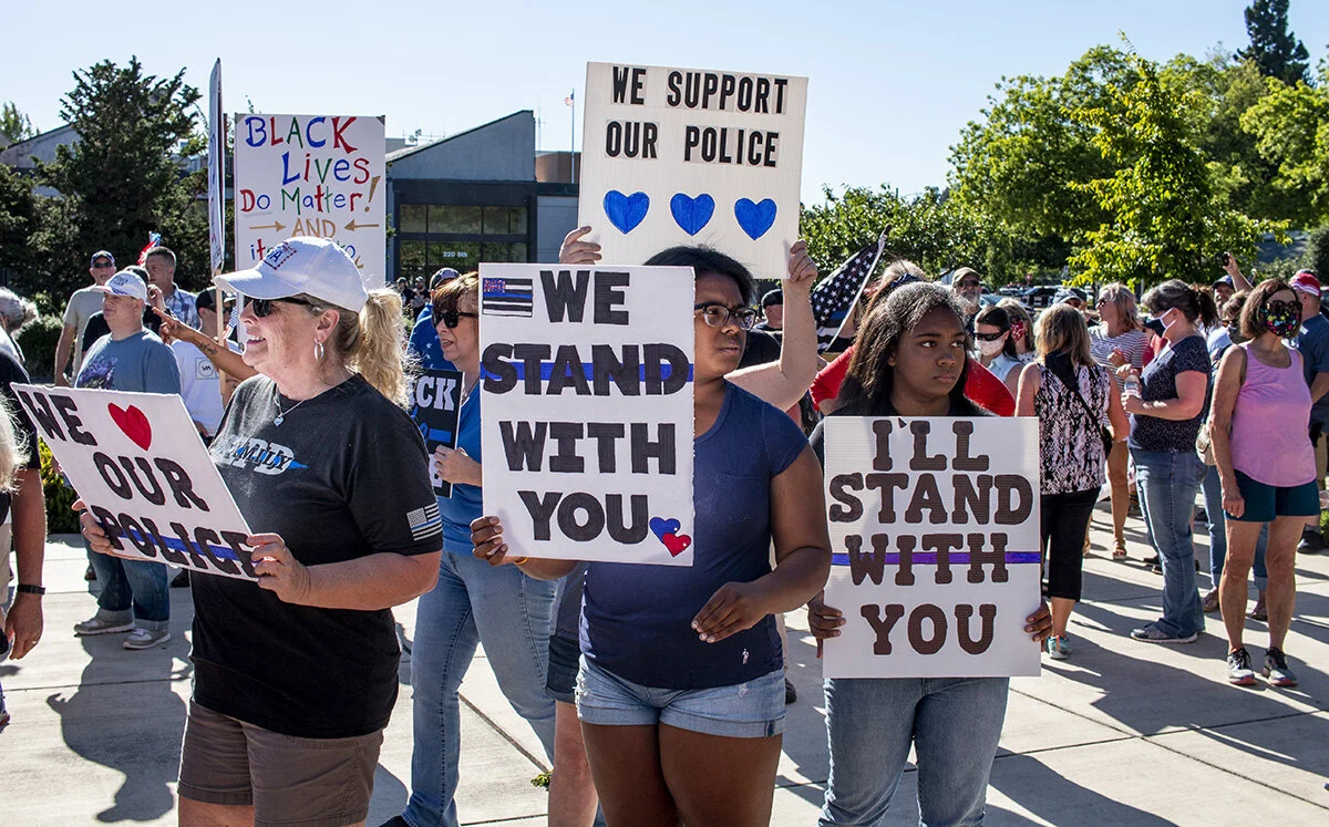  Pro-police demonstrators holding signs in front of the Springfield Public Library. A pro-police rally was held in Springfield, Oregon, Monday afternoon, June 22. The event, organized by Springfield resident Joe Fritz, was intended to show support fo