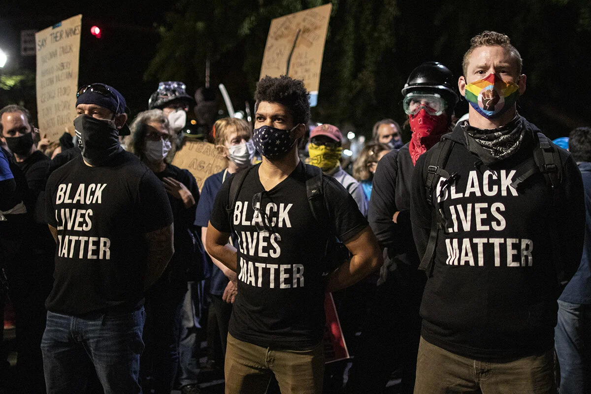  Protesters lining up in front of the fence surrounding the federal courthouse. More than 3000 people showed up Friday, July 24, for the 58th consecutive night of protests at the federal courthouse and Multnomah County Justice Center in Portland, Ore