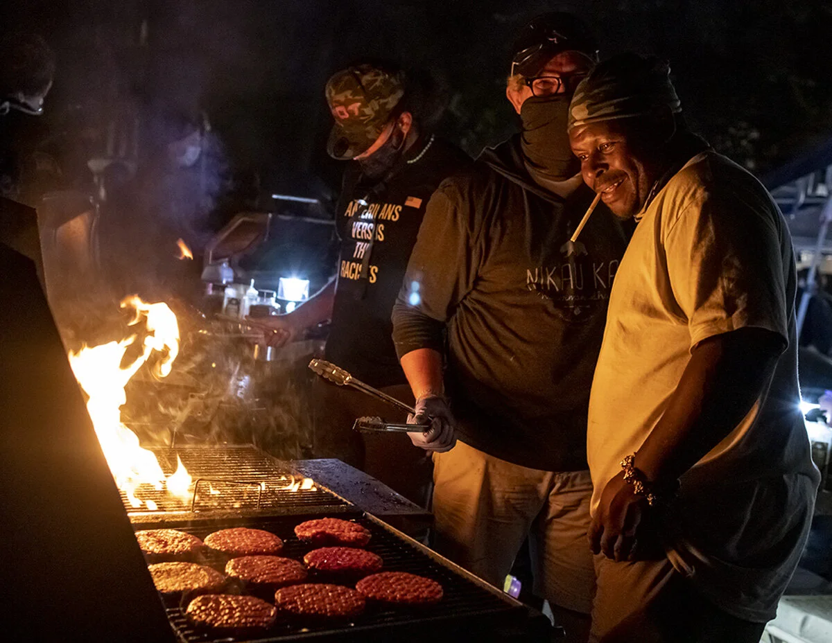  People barbequing burgers to serve to protesters. More than 3000 people showed up Friday, July 24, for the 58th consecutive night of protests at the federal courthouse and Multnomah County Justice Center in Portland, Oregon. The night started with s