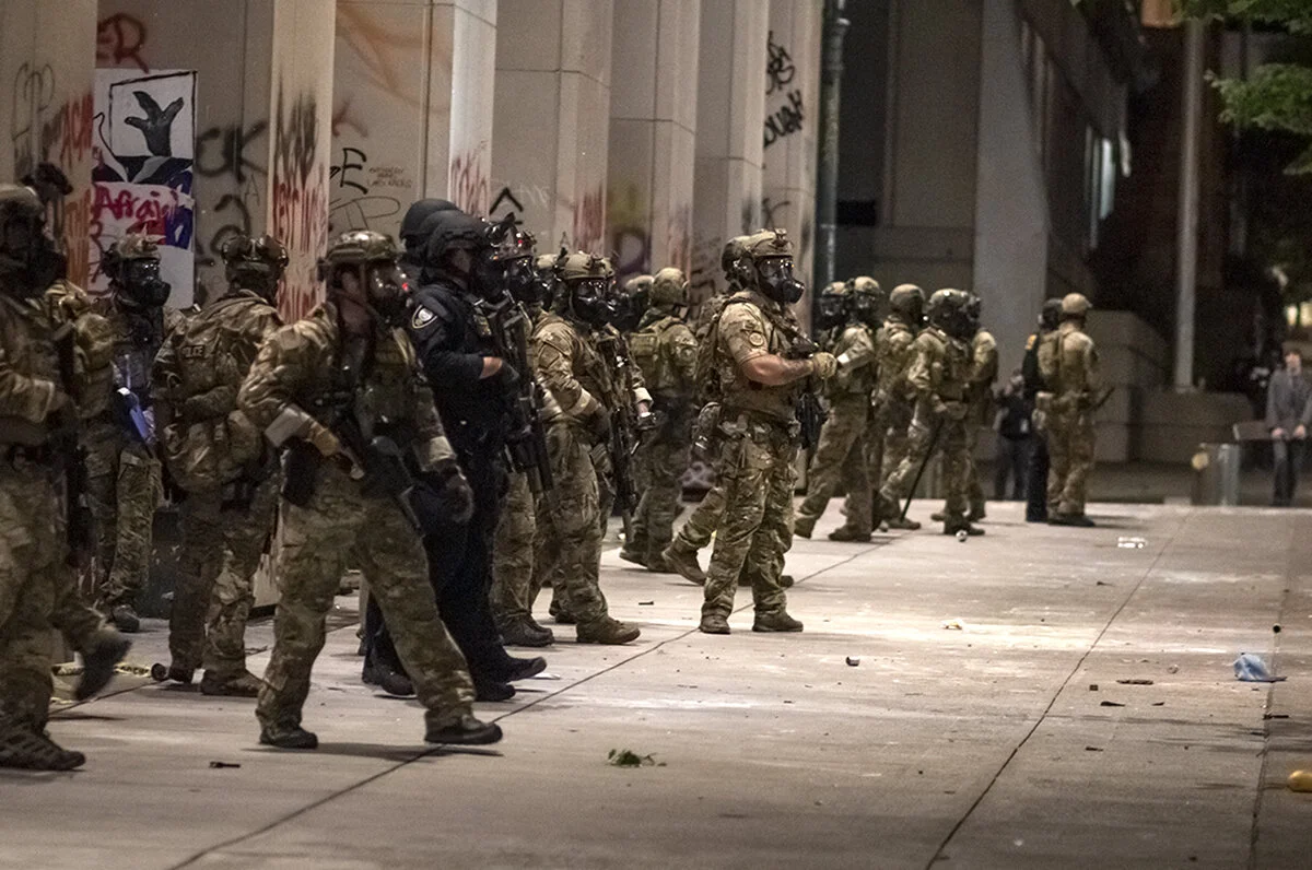  Police announcing that they are preparing to go back inside of the courthouse. Just before they left and shut the courthouse barricade doors, police fired roughly six more cans of tear gas at protesters. Police fired pepper balls and roughly 20 cans
