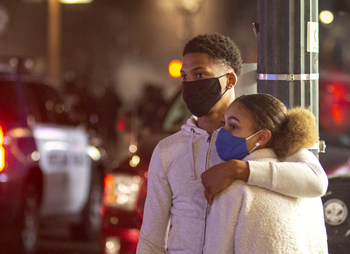  People watching as protesters and Portland police in riot gear march by. Roughly four hundred protesters faced off with the Portland Police Bureau in a tear gas and firework filled encounter at a Fourth of July protest in downtown Portland, Oregon. 