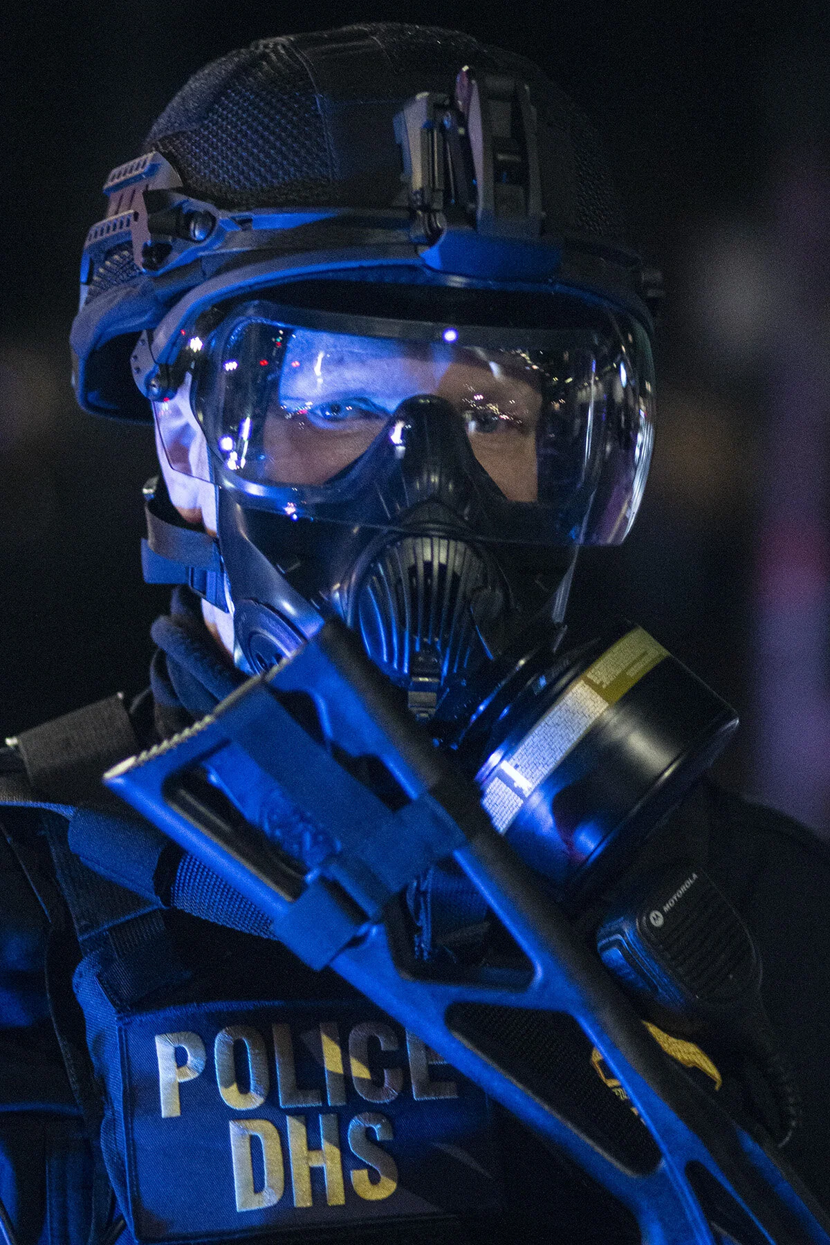  A Homeland Security police officer holding a tear gas launcher watches protesters as other officers block the street leading toward the courthouse. Approximately 3000 protesters gathered outside the Multnomah County Justice Center and the U.S. Distr