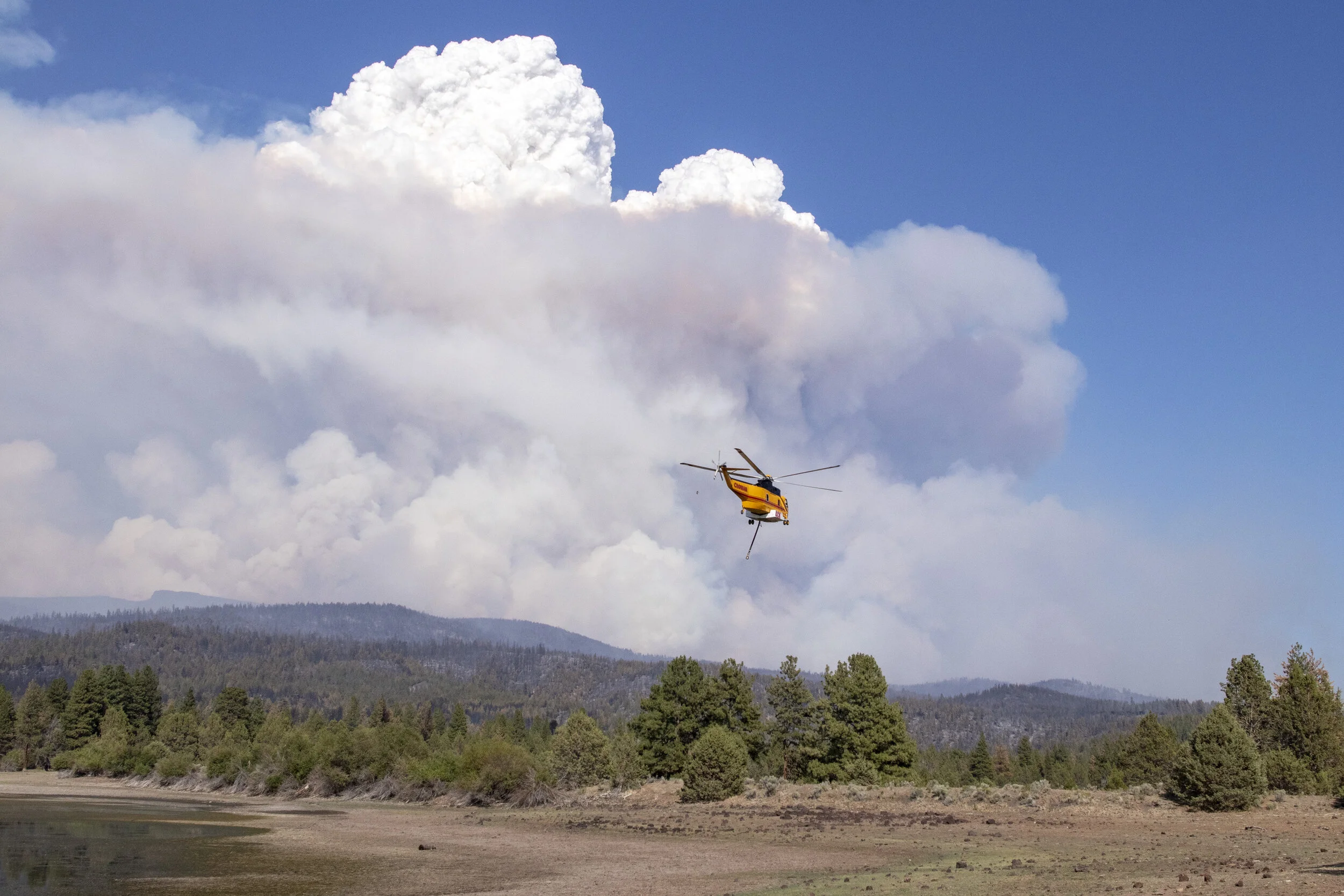  A helicopter transporting a load of water to be dropped on the Bootleg fire. 