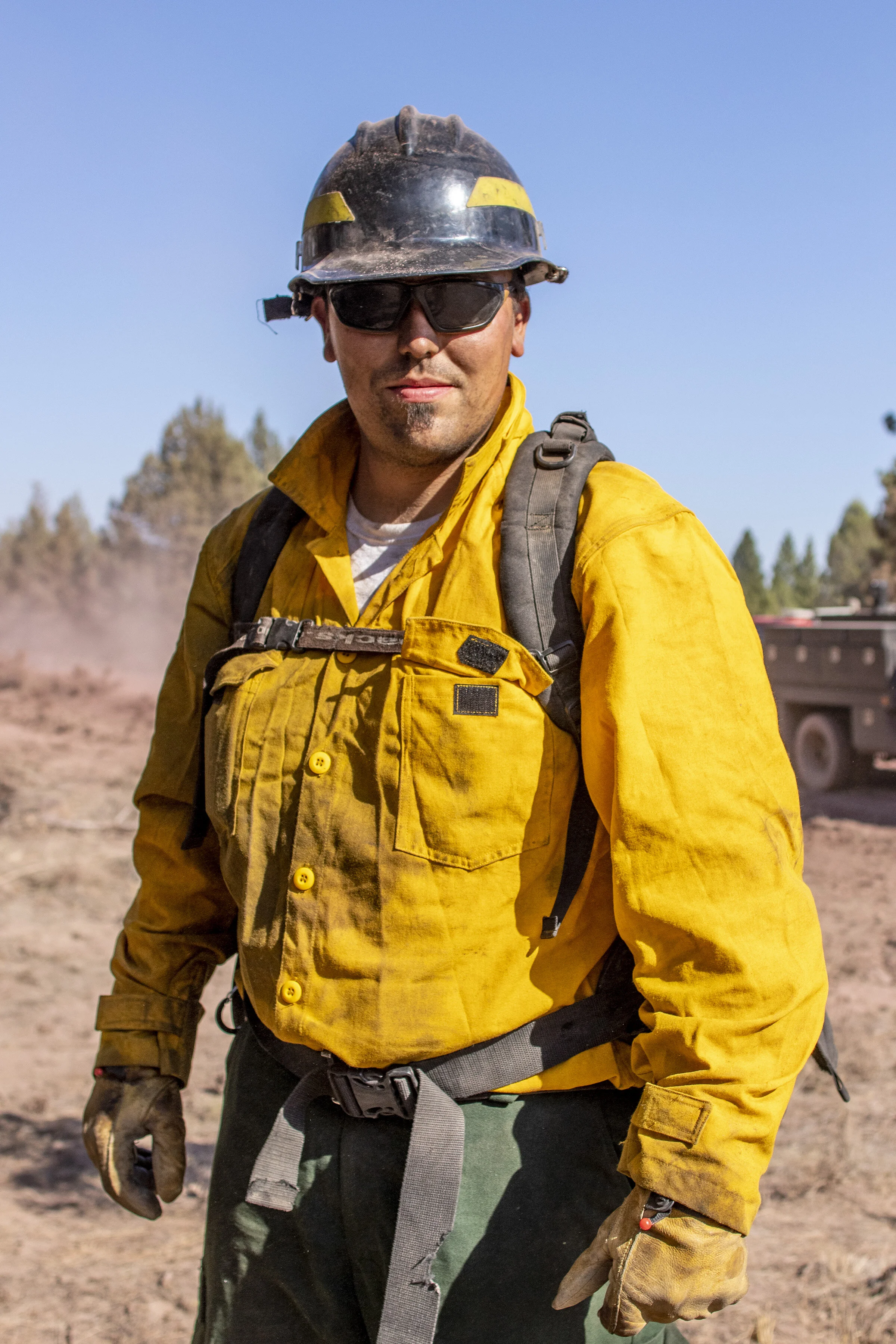  Wildland firefighter Kenny Picard poses for a portrait during mop up operations along the outskirts of the Bootleg Fire in southern Oregon. 