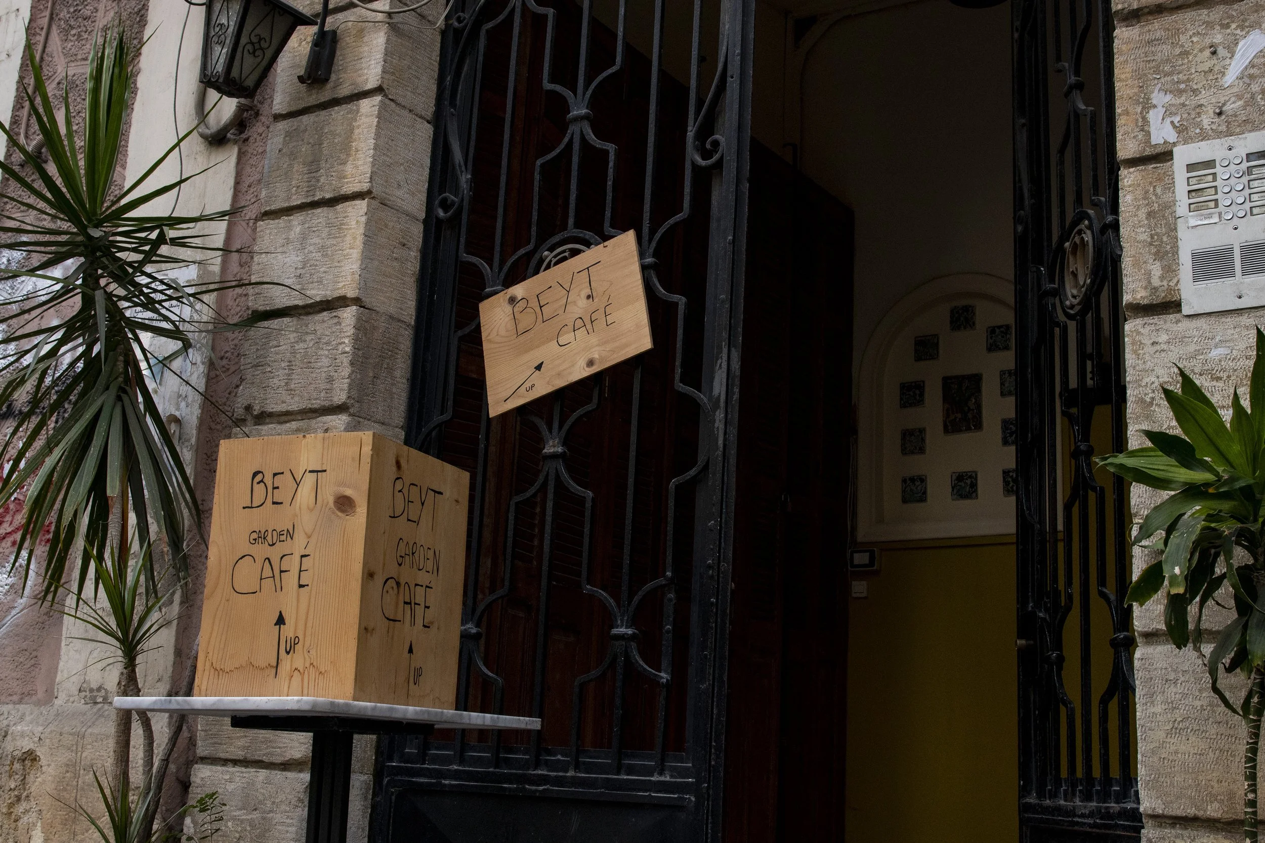  A sign for Beyt Garden Café, located in the Mar Mikhael neighborhood of Beirut, pointing people on the street to the stairway leading to the cafe. 