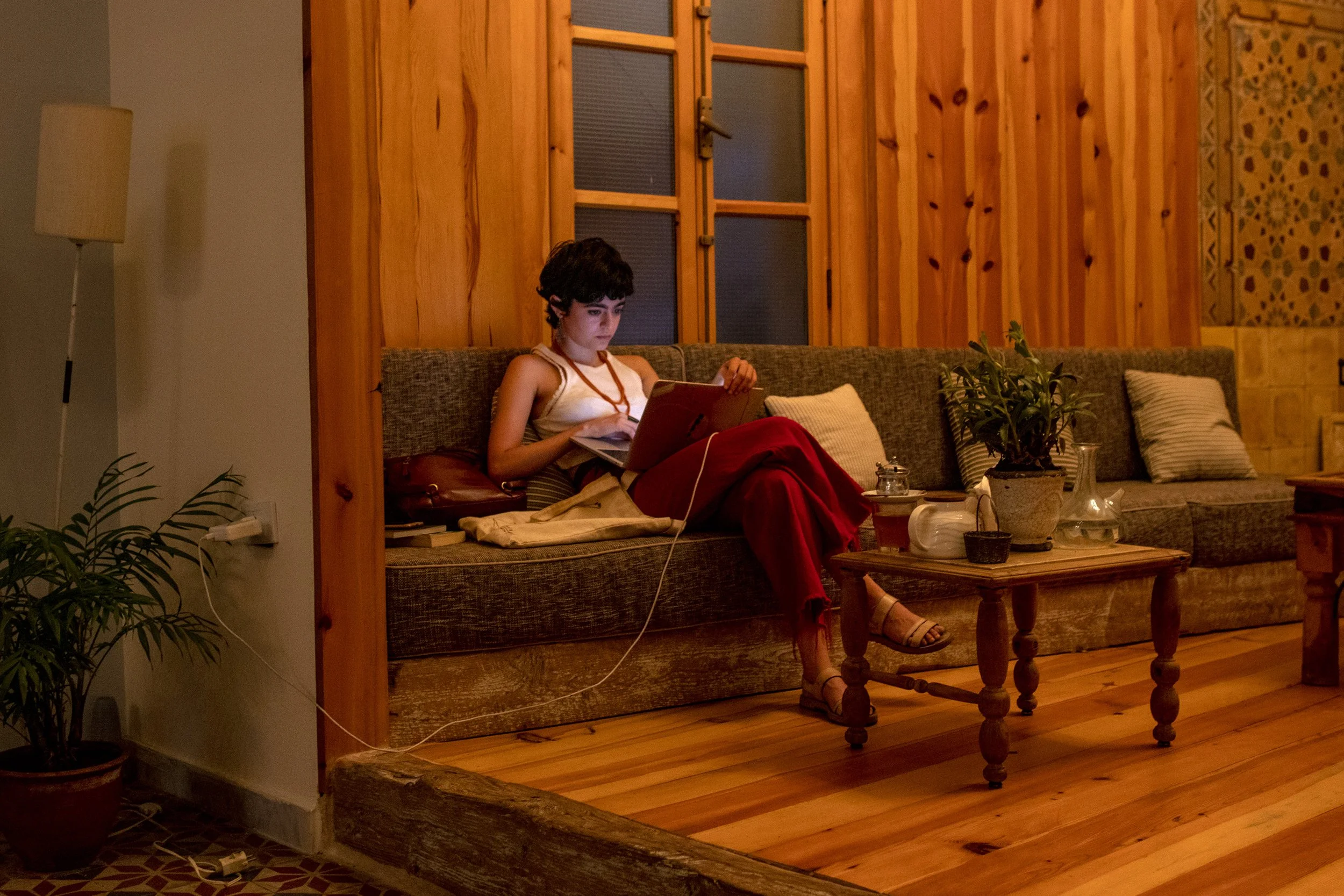  A customer charging her laptop at a lounging area in the caf3. Algelany said despite the difficulties in keeping Beyt Garden Café open, everyone behind the cafe was determined to keep it running and viewed the business as a service to the public. “W