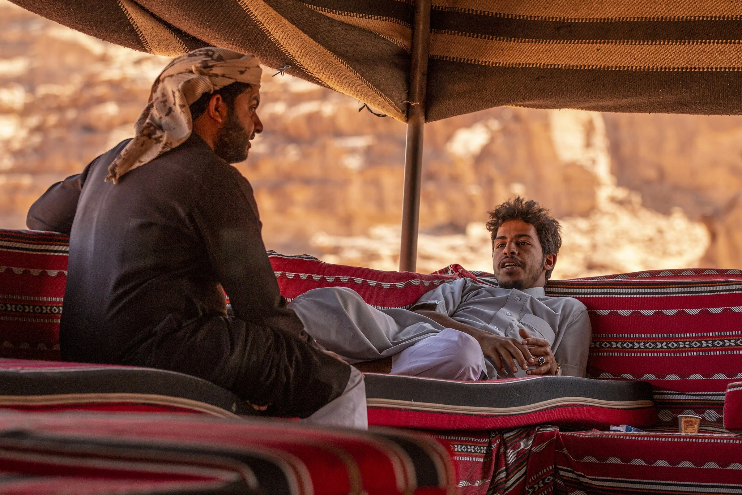  24-year-old Bedouin tribesman Mahmoad Zawayedah, right, resting inside a tent after leading a jeep tour through Wadi Rum. Zawayedah said he has lived in Wadi Rum his entire life. 