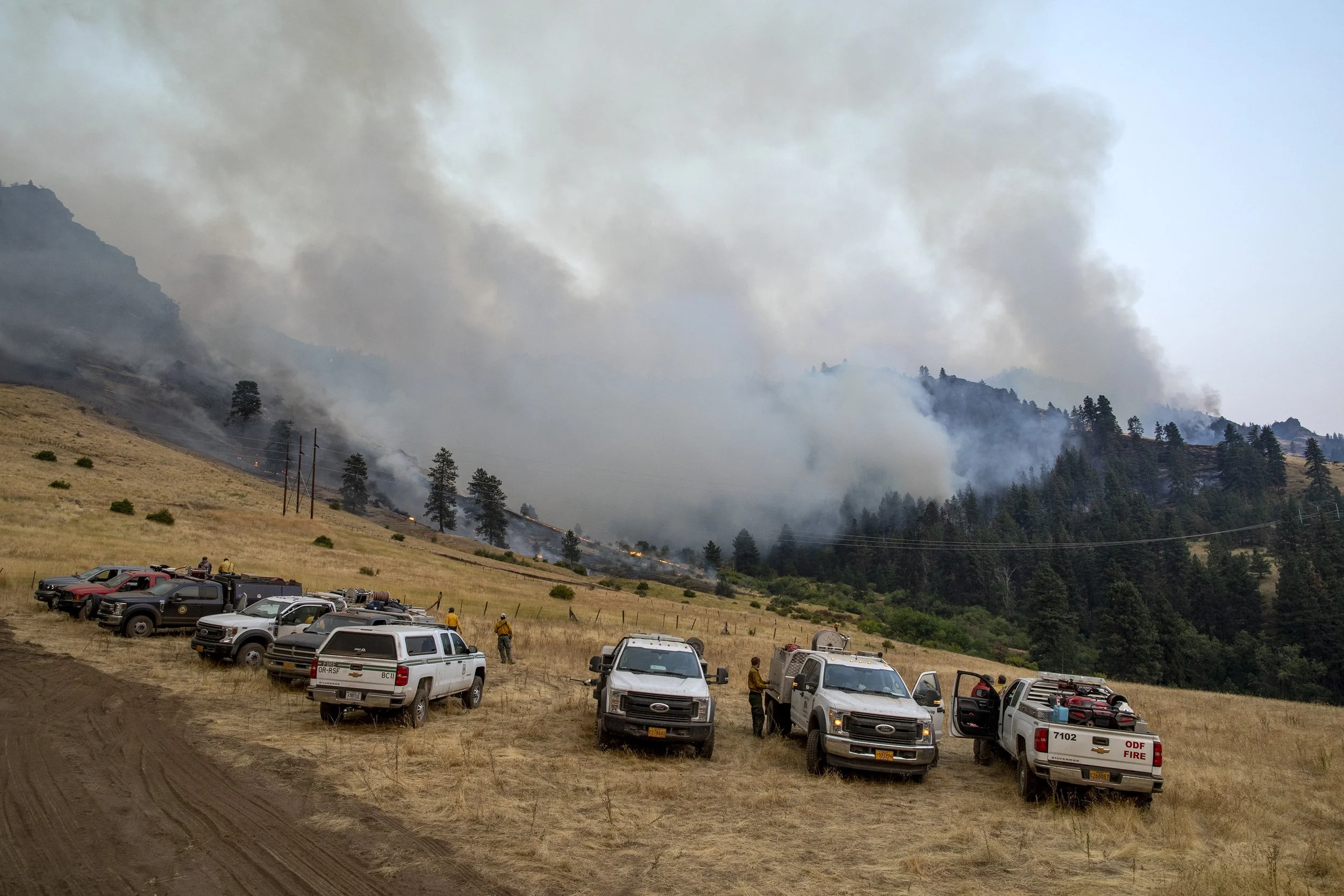  Firefighters line up as they prepare to monitor and suppress the Double Creek fire throughout the night. 