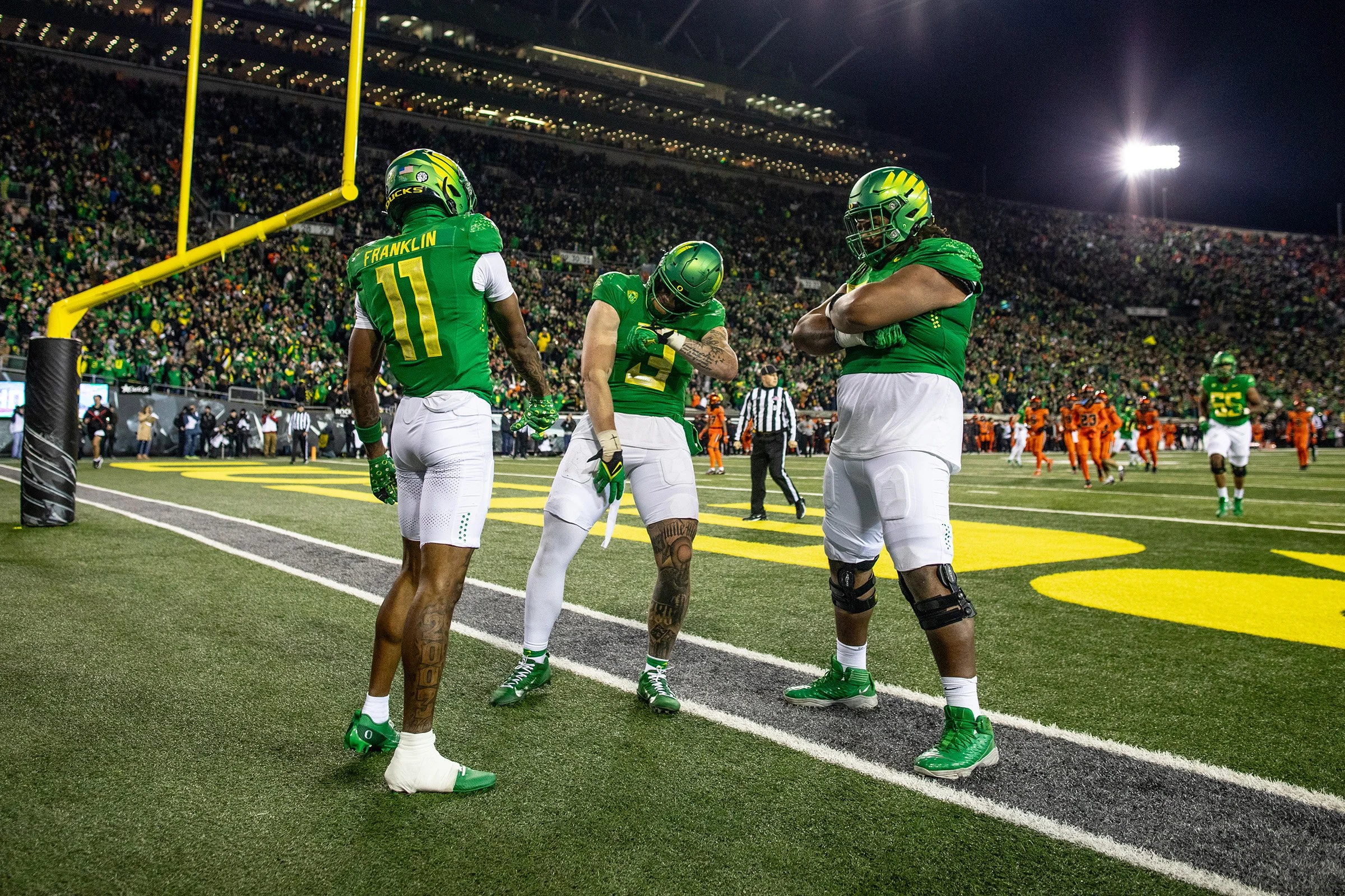  Oregon Ducks players celebrating after a touchdown. The University of Oregon Ducks defeated the Oregon State University Beavers 31-7 in what could be a historic end to the teams’ rivalry as the Ducks leave the Pac-12 to join the Big Ten conference. 