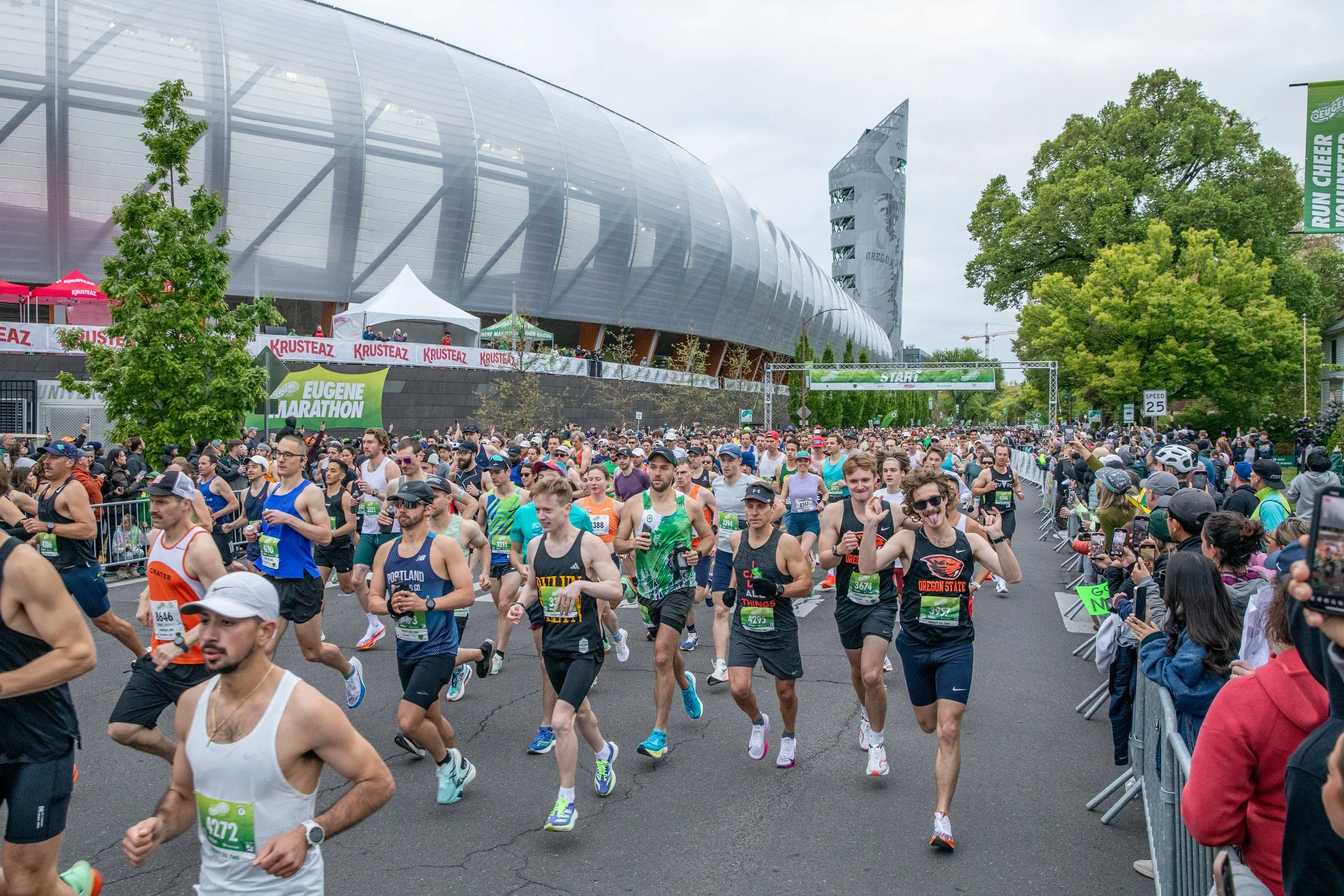  Thousands of runners take off past Hayward Field after crossing the starting line of the Eugene Marathon on April 27, 2025.  