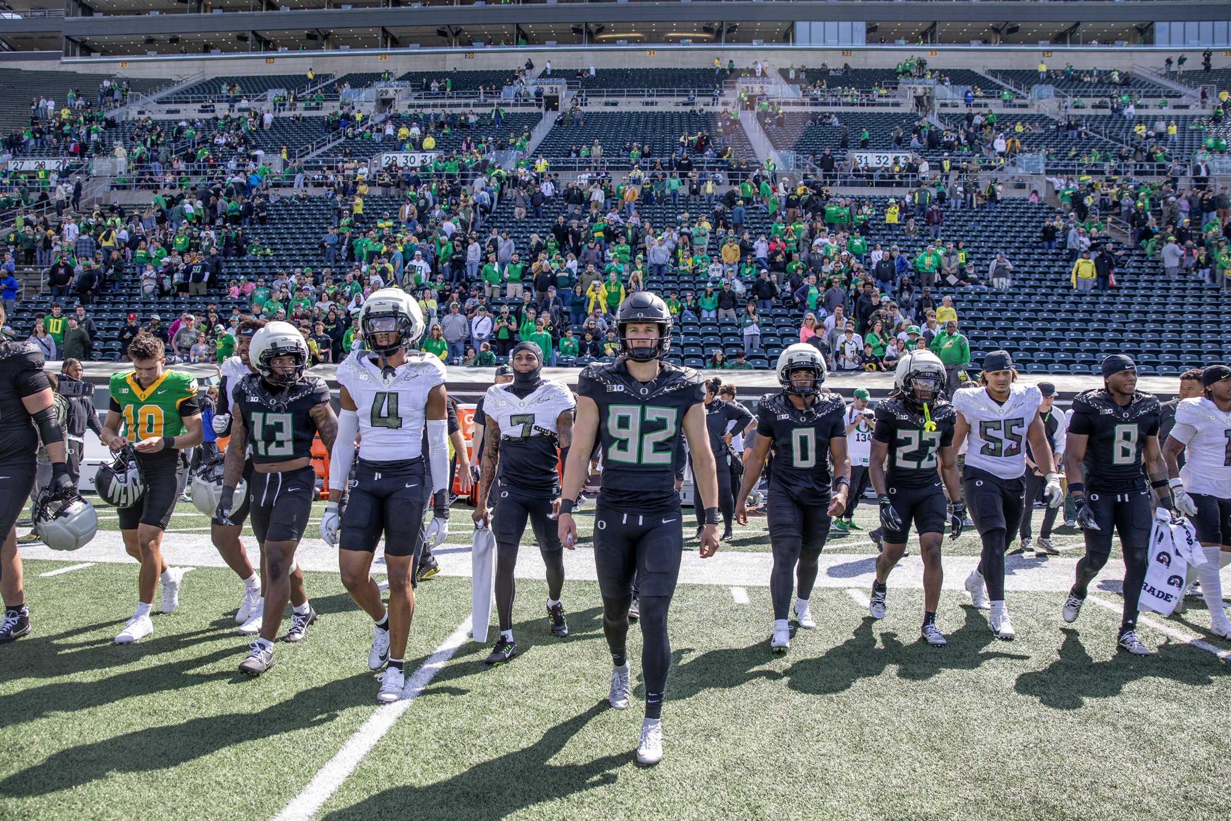  Oregon Ducks football players walk onto the field after the end of the UO Spring Game at Autzen Stadium Saturday, April 26, 2025. Defensive plays were the highlight of the game with 11 combined sacks between the two teams and a fumble return resulti