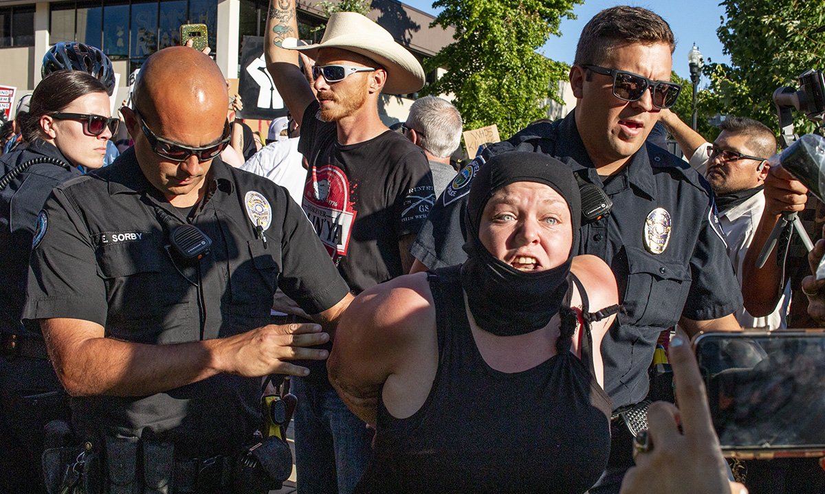  Springfield police officers detain a counter-protester during a pro-police rally on June 22, 2020, in Springfield, Oregon. 