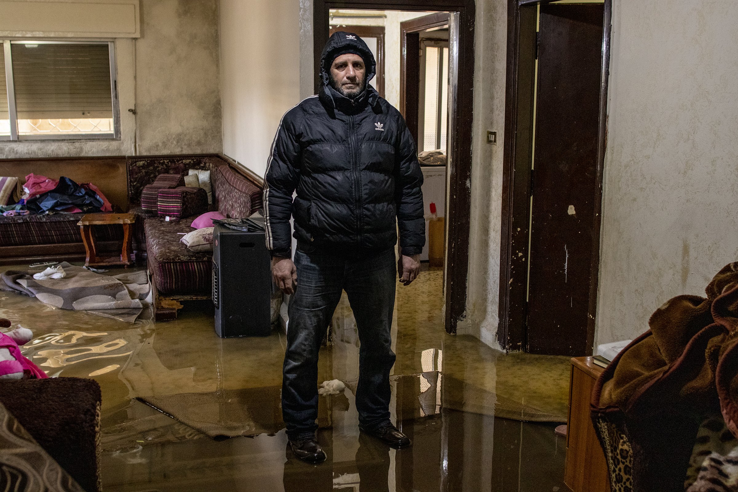  Amman, Jordan, resident&nbsp;Ahmad Jaber al-Attiat&nbsp;stands in the middle of his flooded apartment where he lives with his wife and four children. Alattiat's apartment flooded after approximately two feet of snow fell in Amman overnight. 